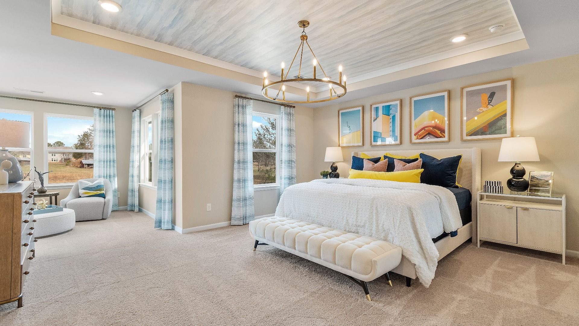 Spacious primary bedroom with large windows, trayed ceiling, and neutral finishes at Cooper Park in McDonough, GA.