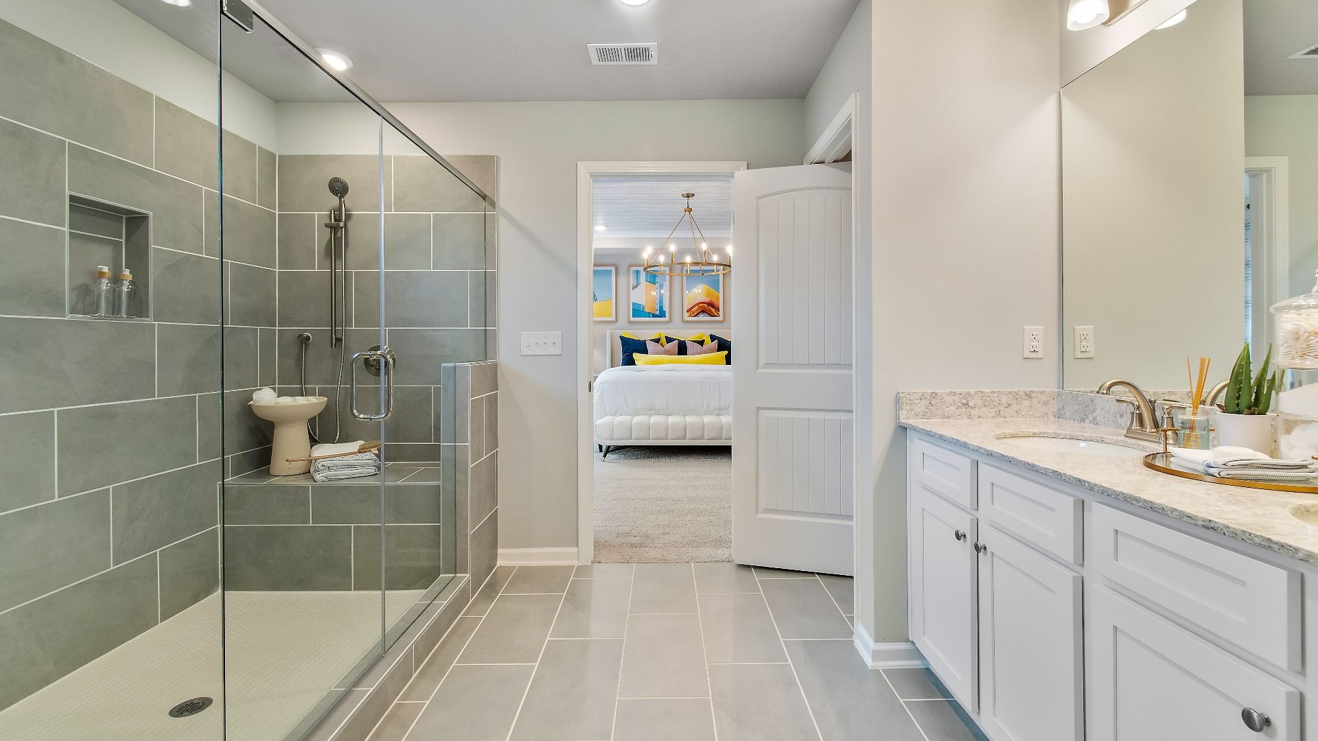 Primary bath with walk-in shower, dual vanities, and elegant modern design at Cooper Park in McDonough, GA.