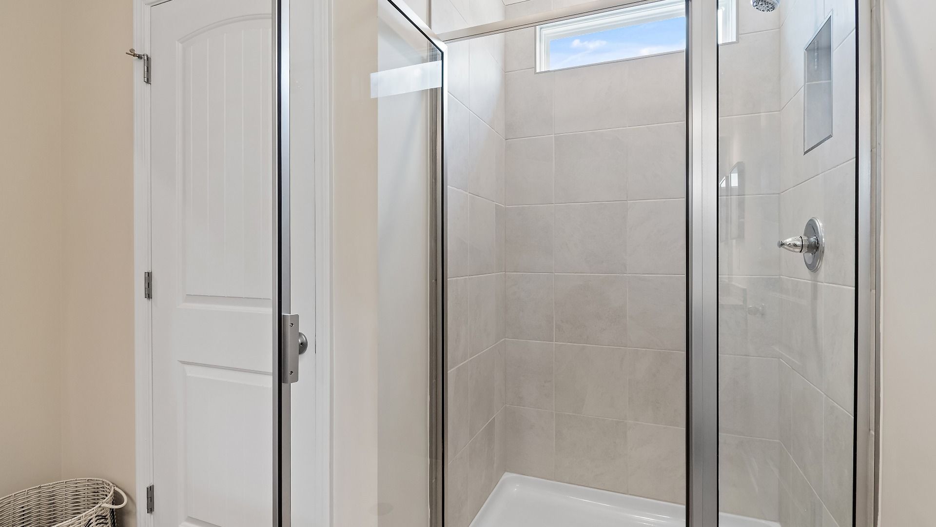 Primary bath walk-in shower with tiled wall detail in Millhaven homeplan at Abbotts Crossing in Conyers, GA.