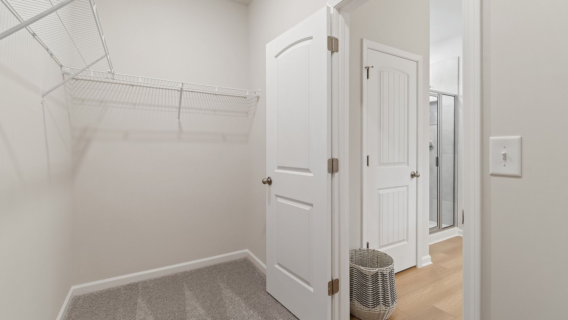 Spacious walk-in closet connecting to primary bath in Millhaven plan at Abbotts Crossing in Conyers, GA.