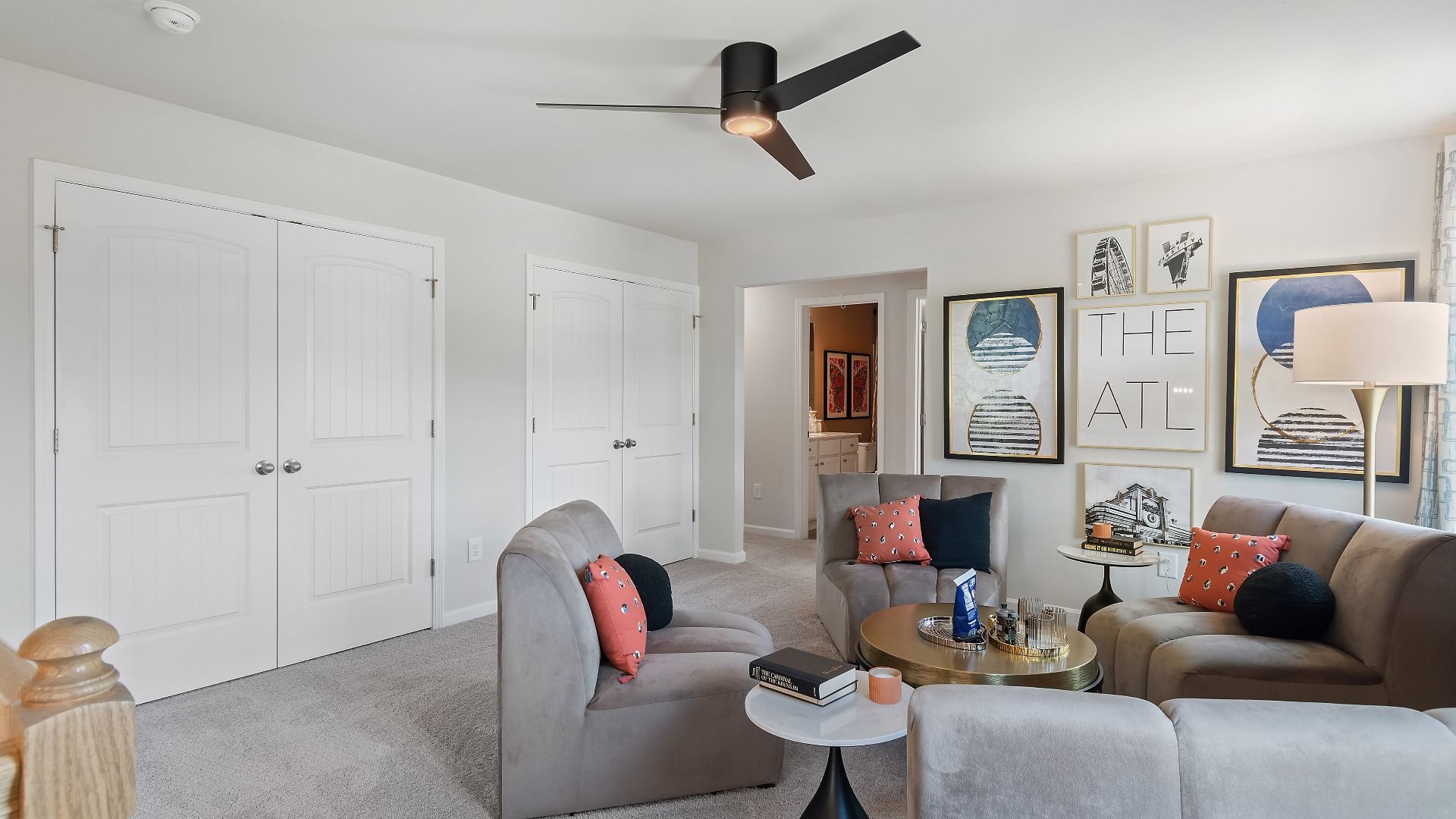 Millhaven loft with generous seating area and carpet flooring at Abbotts Crossing in Conyers, GA.