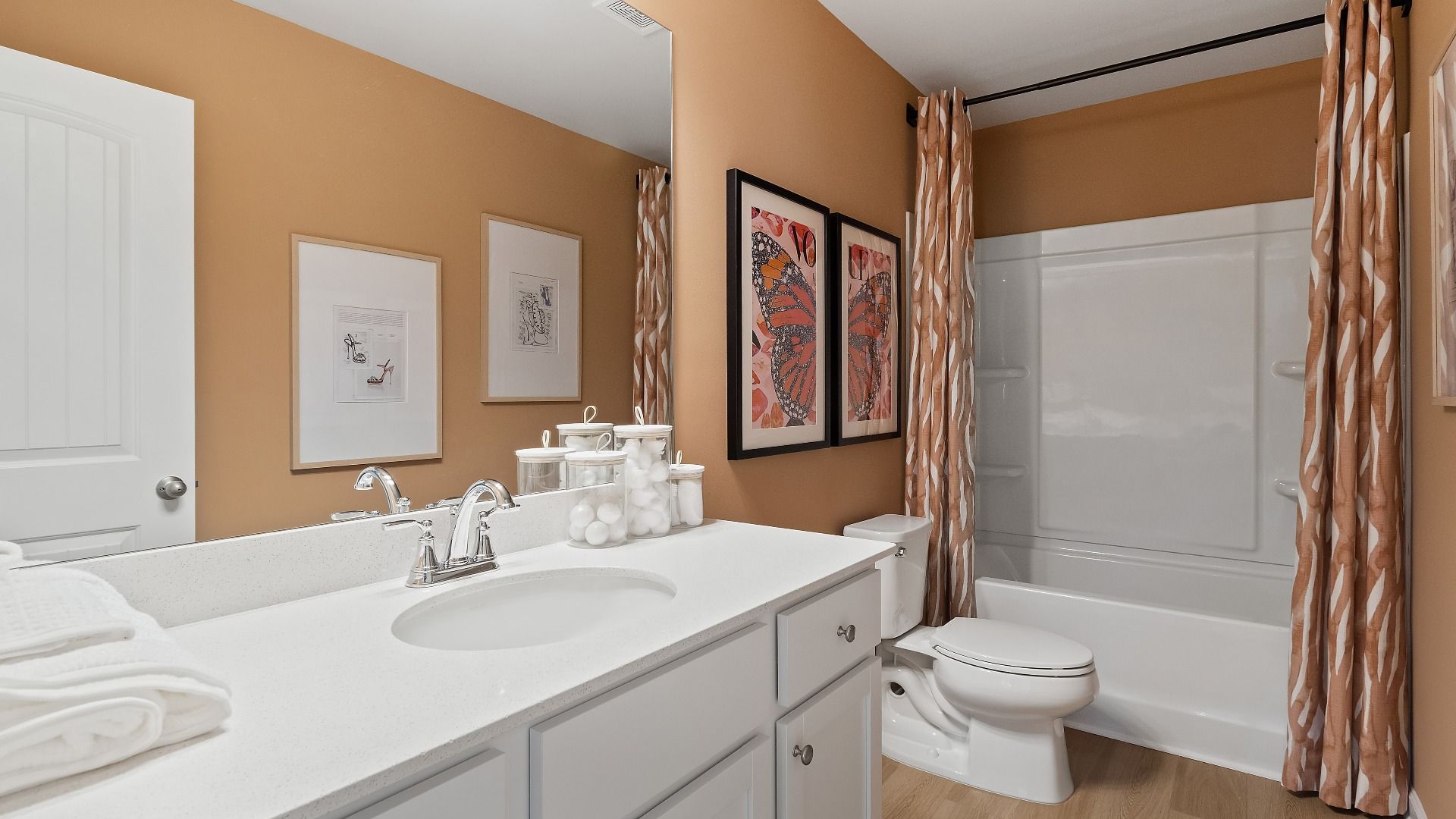 Millhaven secondary bath with tub shower and LVP flooring at Abbotts Crossing in Conyers, GA.