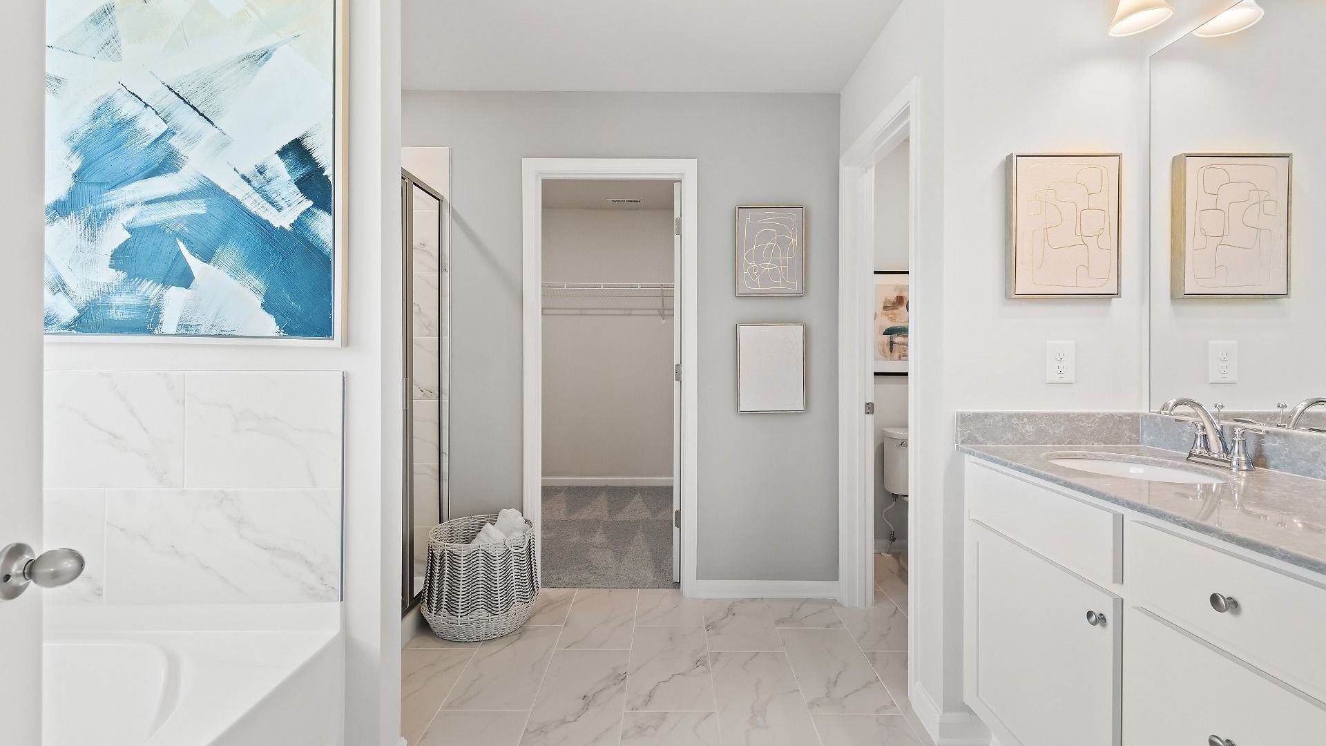 Modern primary bath with dual vanities, drop-in tub, and walk-in shower in the Millhaven at Abbotts Crossing in Conyers, GA.