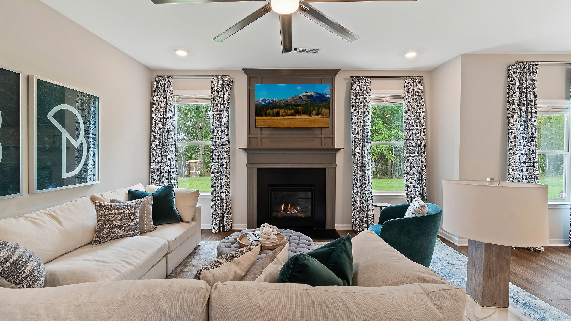 Family room with gas fireplace, abundant natural light, and modern finishes in the Isabella II at Adagio in Dacula, GA.