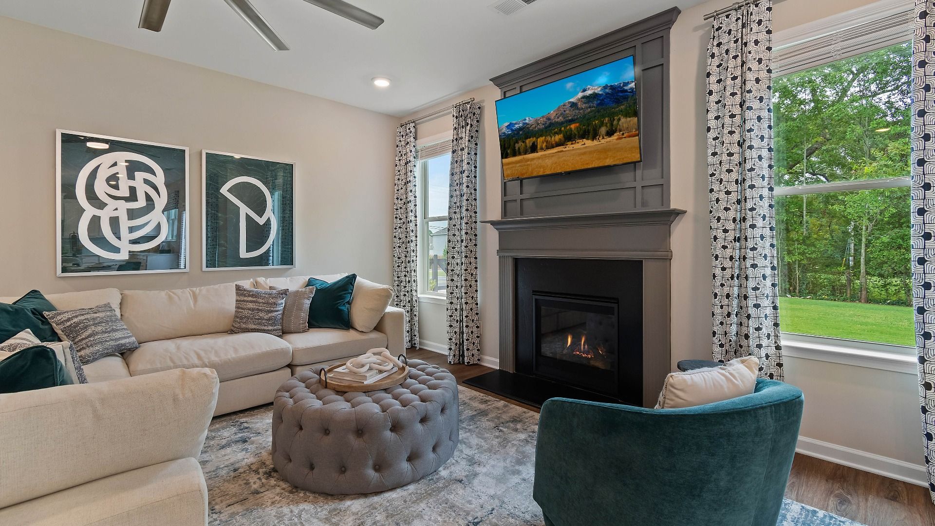 Spacious family room with LVP flooring, gas fireplace with accent mantel, and natural light in the Isabella II at Adagio.