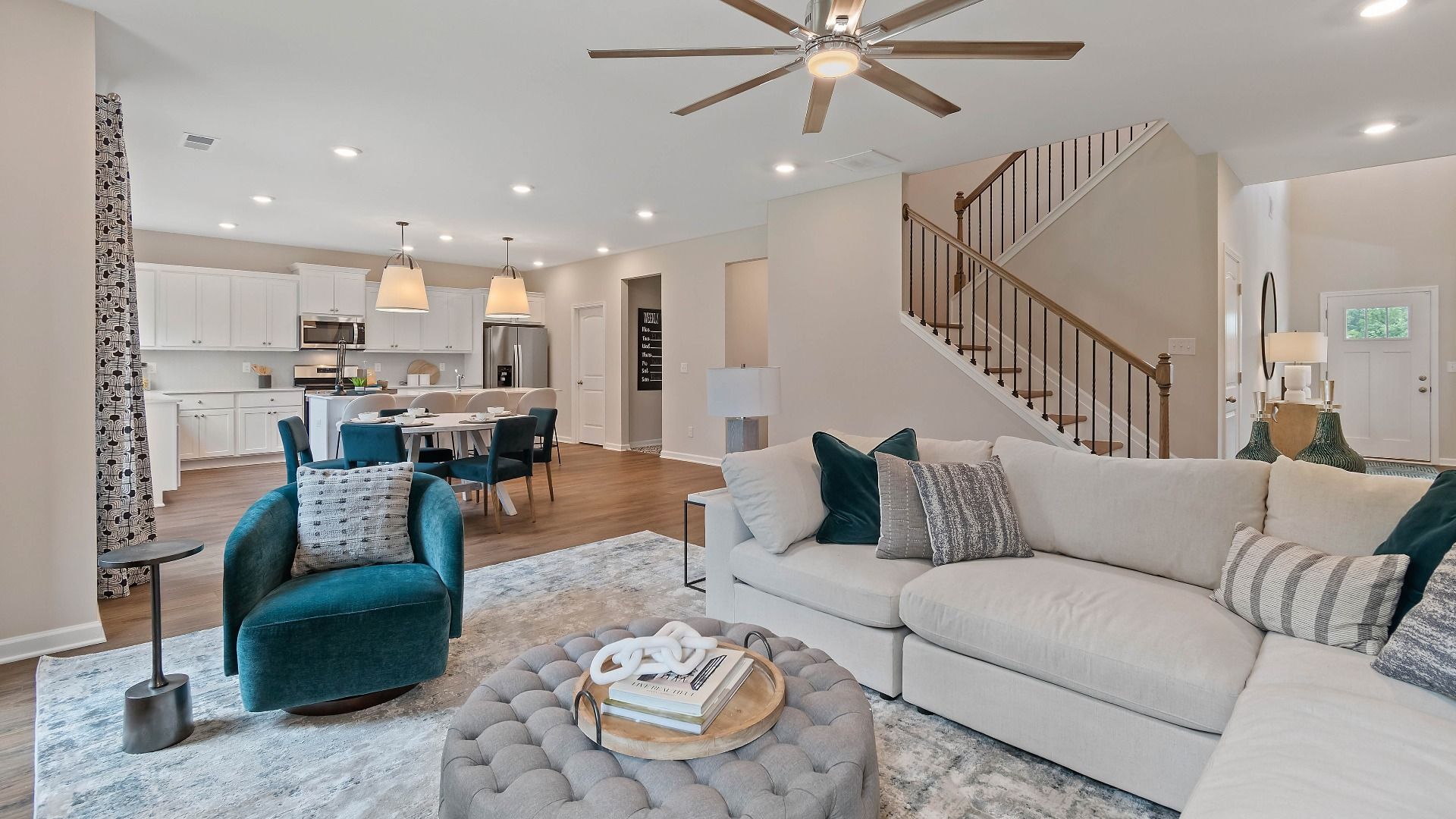 Open family room with generous seating area and seamless flow from entry into the breakfast area in Isabella II at Adagio.