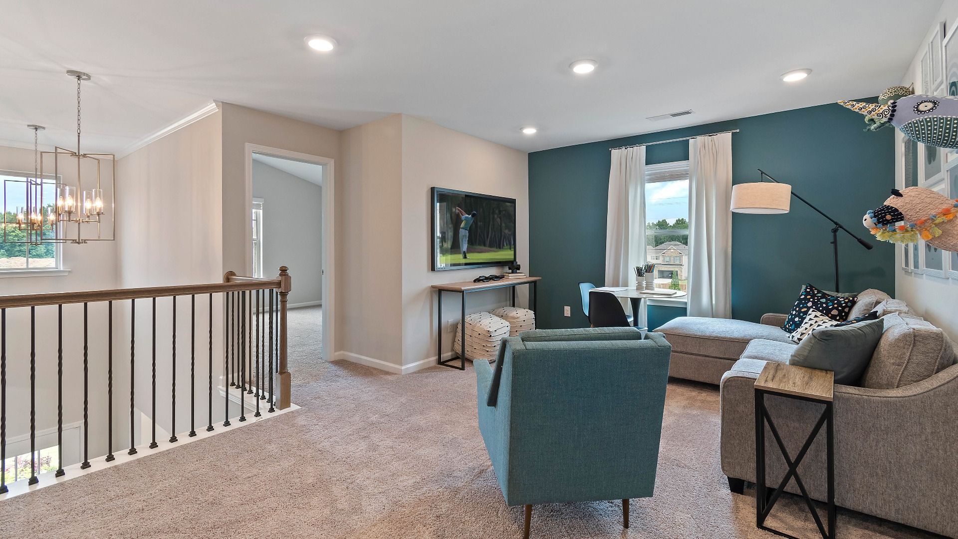 Loft area with comfortable lounge space, carpet flooring, and natural light in the Isabella II at Adagio in Dacula, GA.