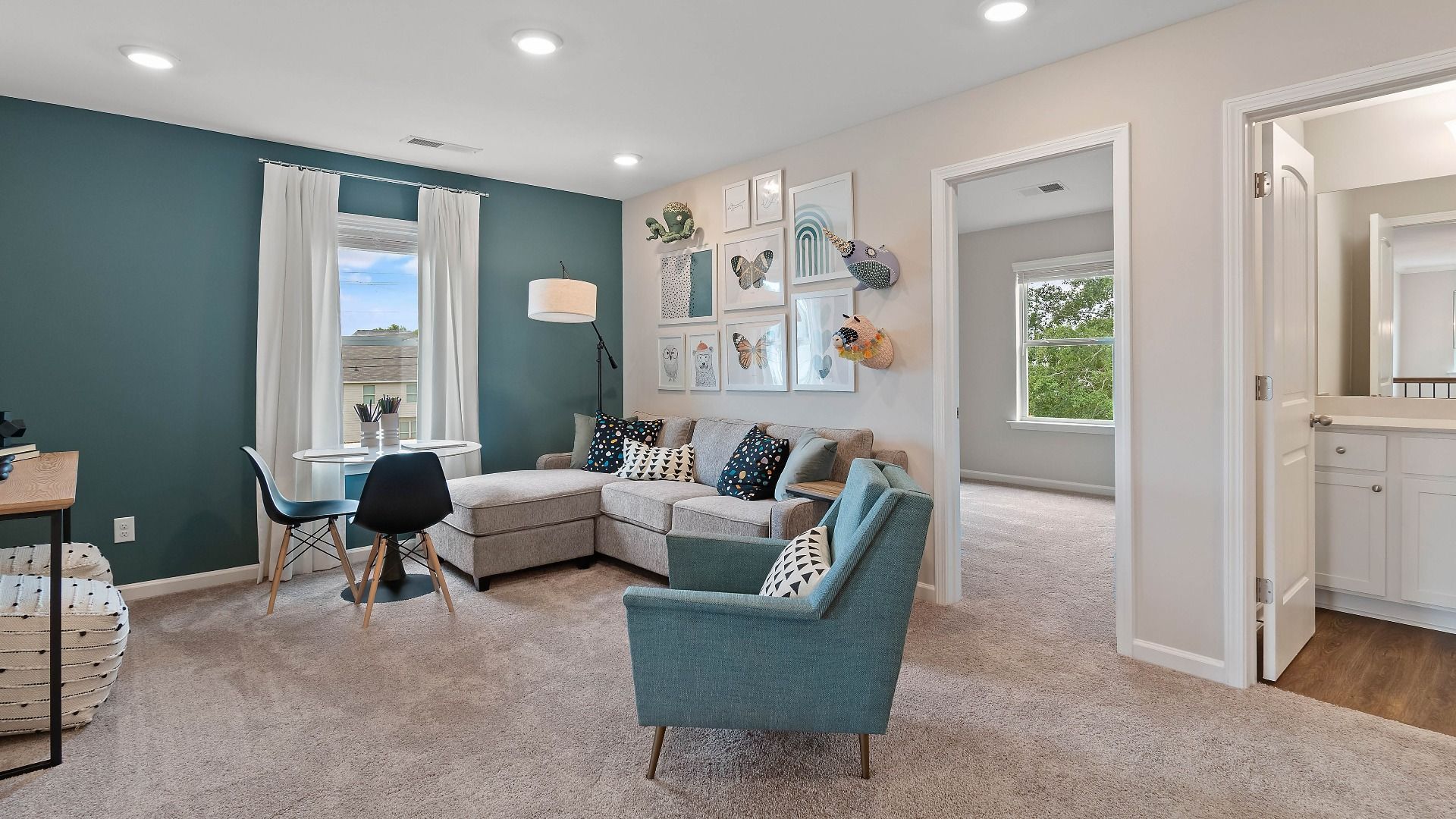 Spacious loft area for work or lounge use with carpet flooring and natural light in the Isabella II at Adagio in Dacula, GA.