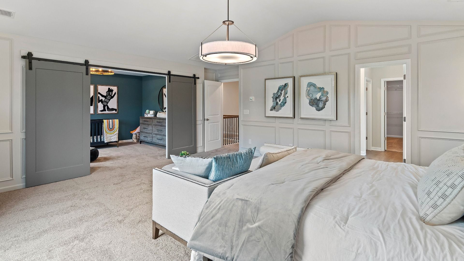 Luxury primary suite with carpet flooring and adjoining seating room in the Isabella II at Adagio in Dacula, GA.