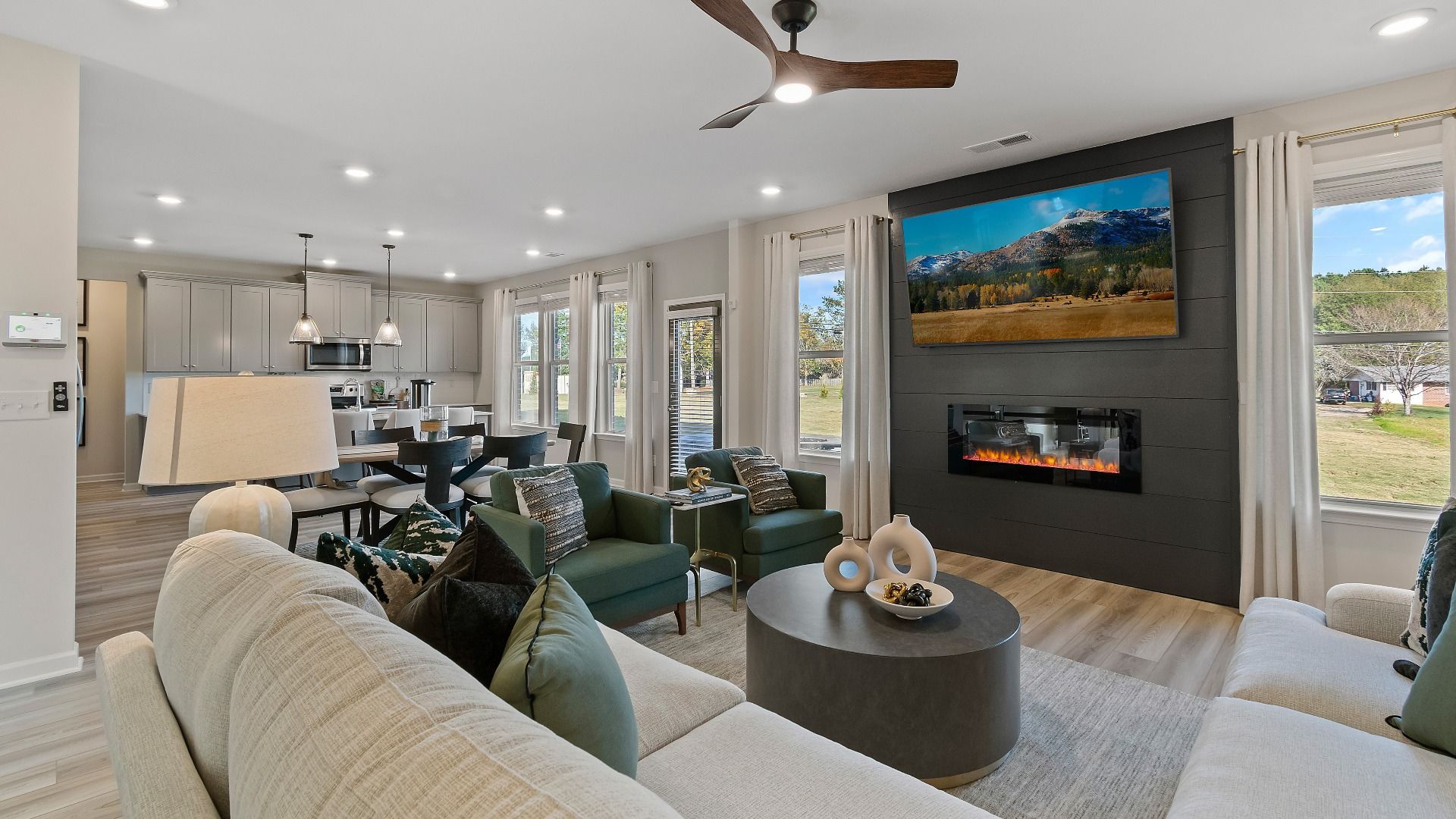 Bright family room with open layout, contemporary finishes, and natural light in Adagio community home in Dacula, GA.