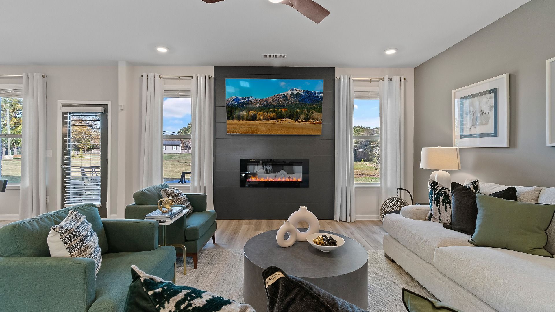 Bright family room with open layout, contemporary finishes, and natural light in Adagio community home in Dacula, GA.