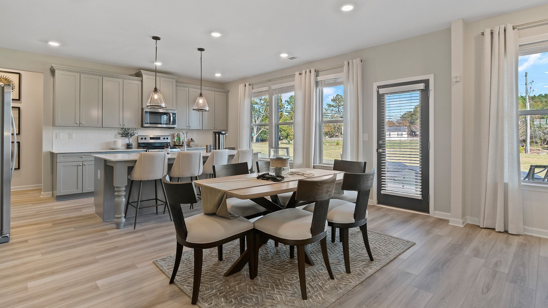 Eat-in breakfast area with bright windows and contemporary finishes in new construction home at Adagio in Dacula, GA.