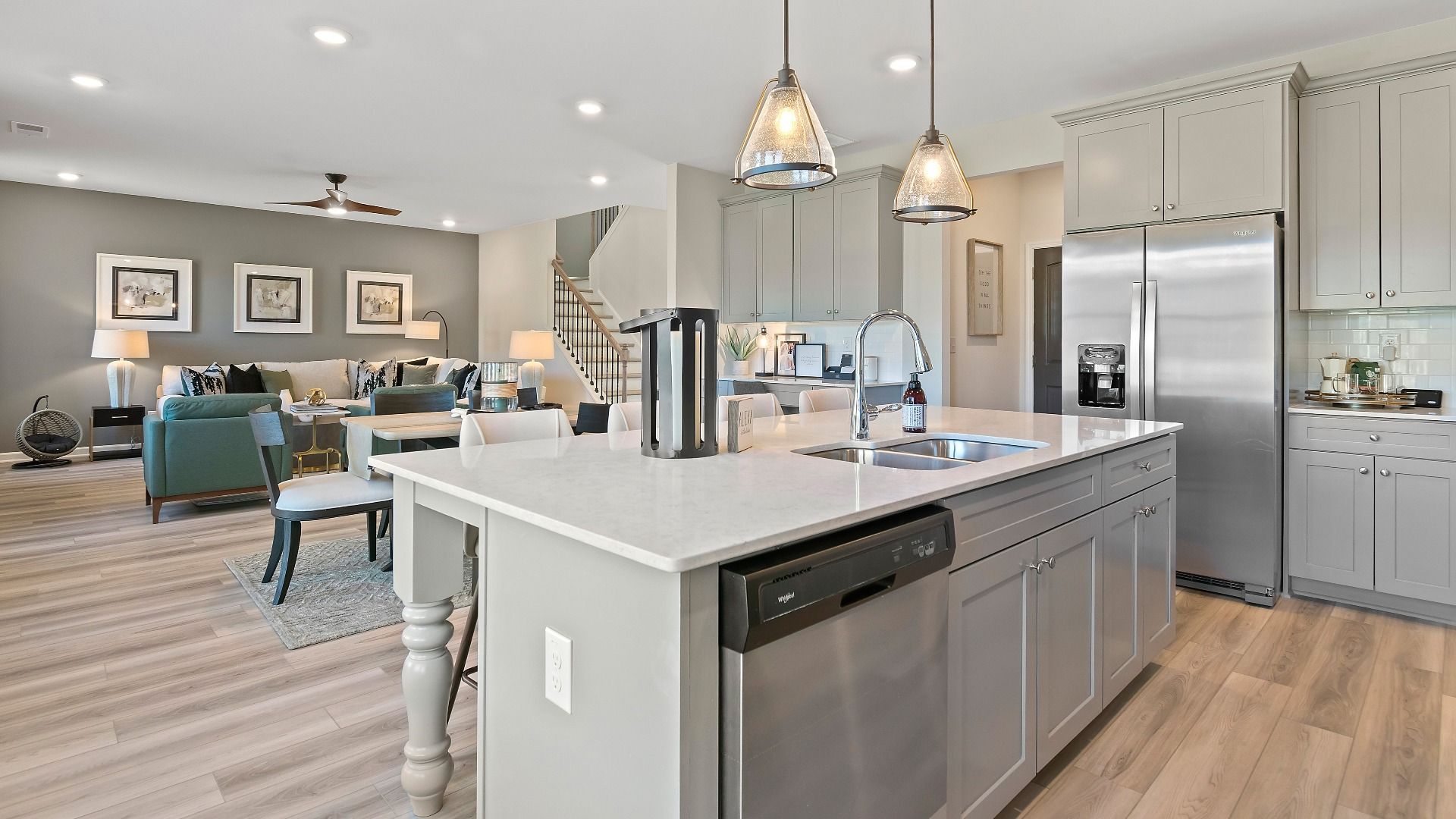 Modern gray kitchen with expansive island and stainless steel appliances in new construction home in Dacula, GA.