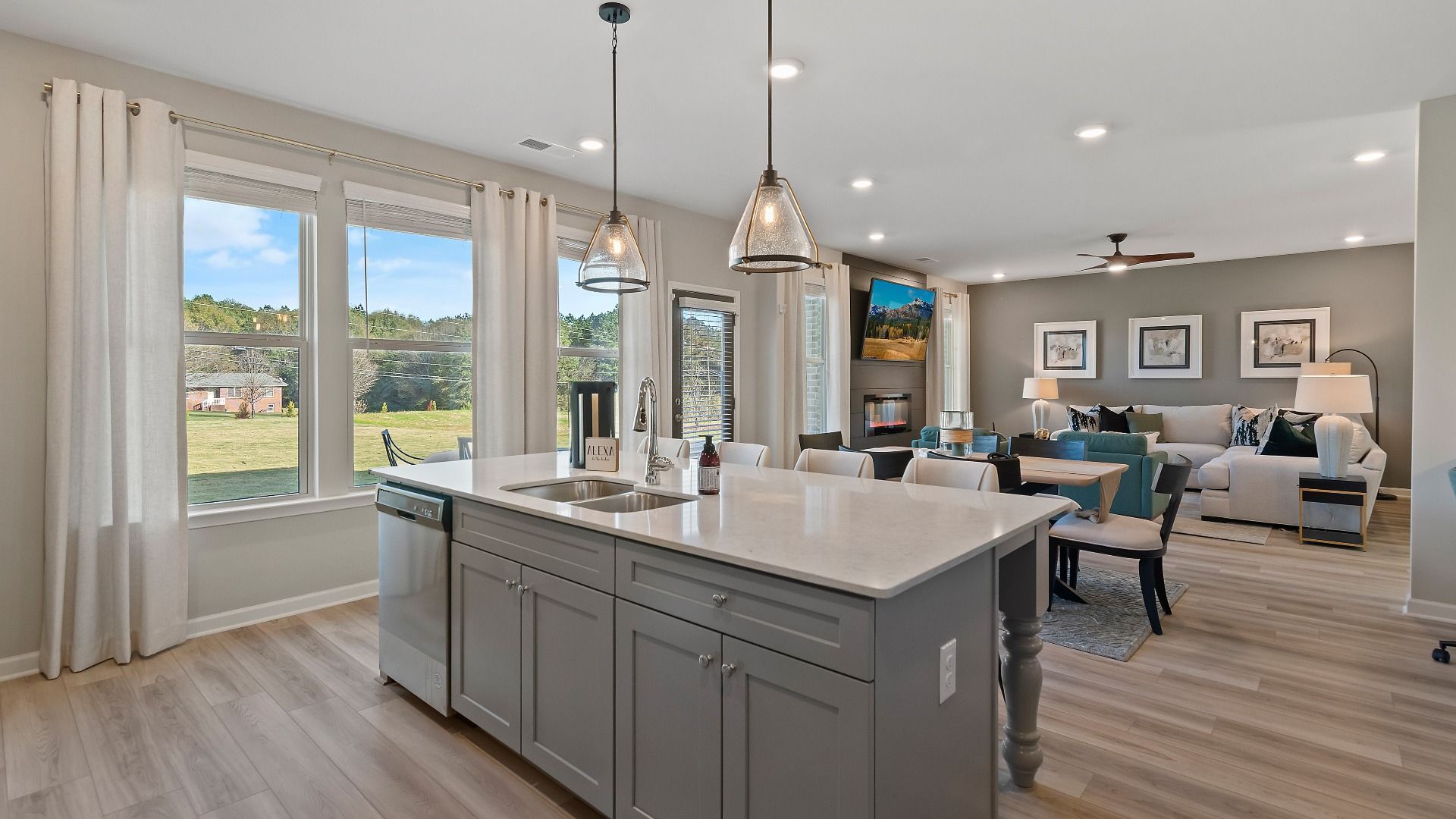 Modern gray kitchen with expansive island and stainless steel appliances in new construction home in Dacula, GA.