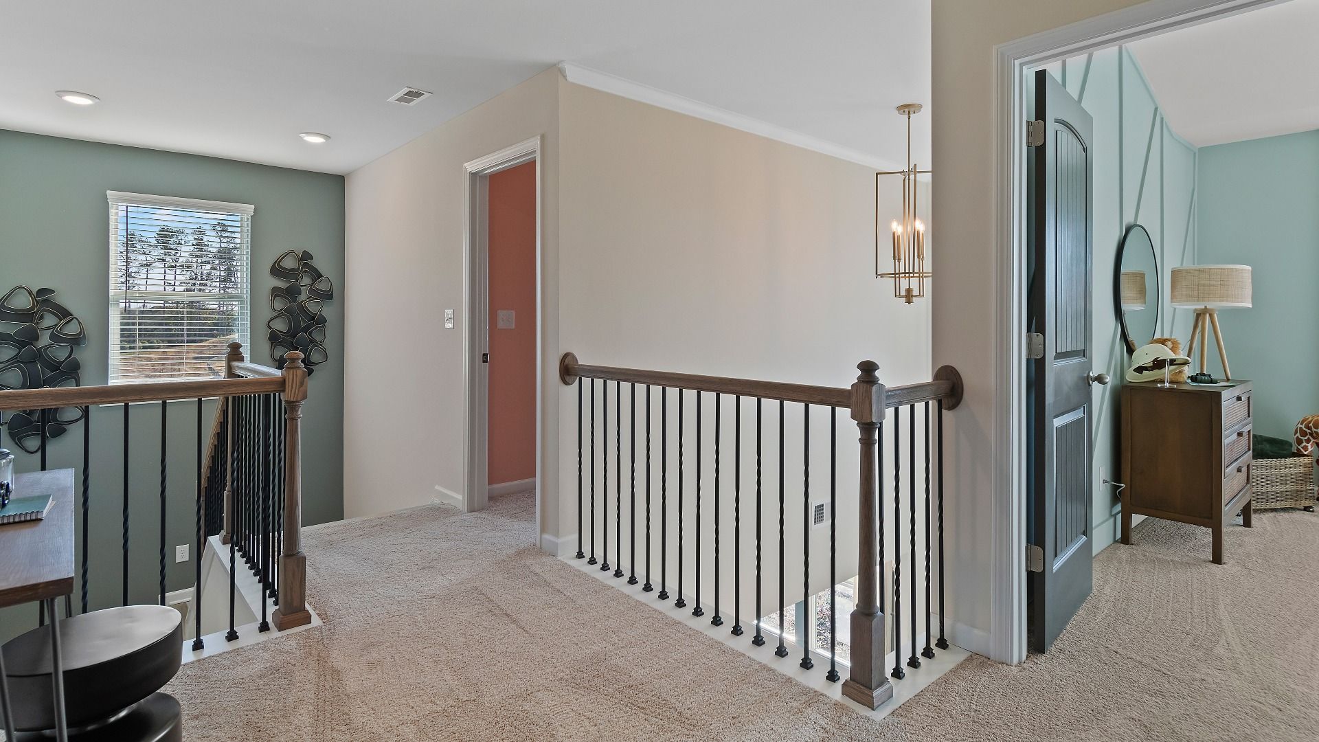 Open upstairs landing with modern railing and natural light in new construction home at Adagio in Dacula, GA.