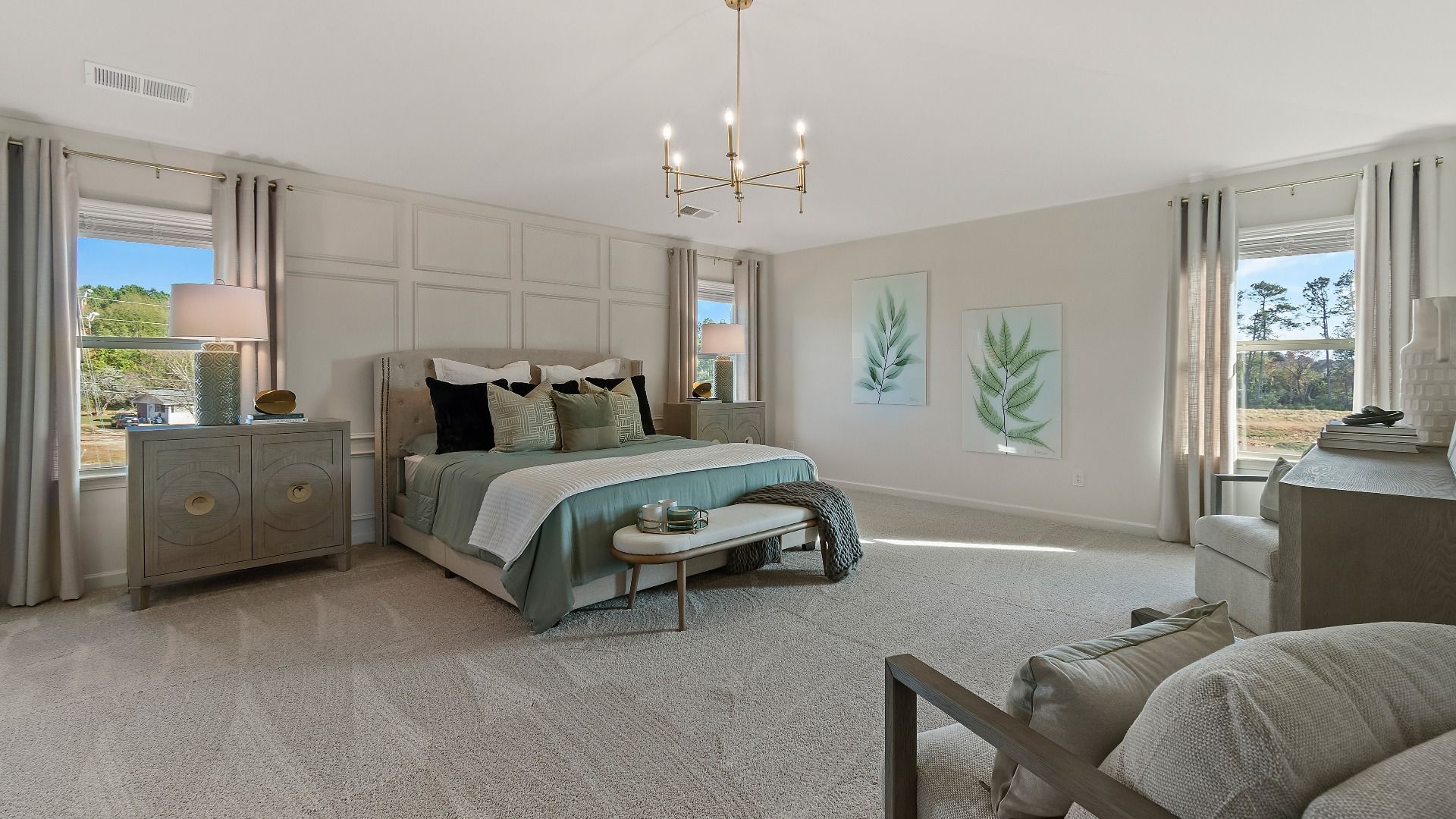 Spacious primary suite with large windows, neutral décor, and abundant natural light in new construction home in Dacula, GA.