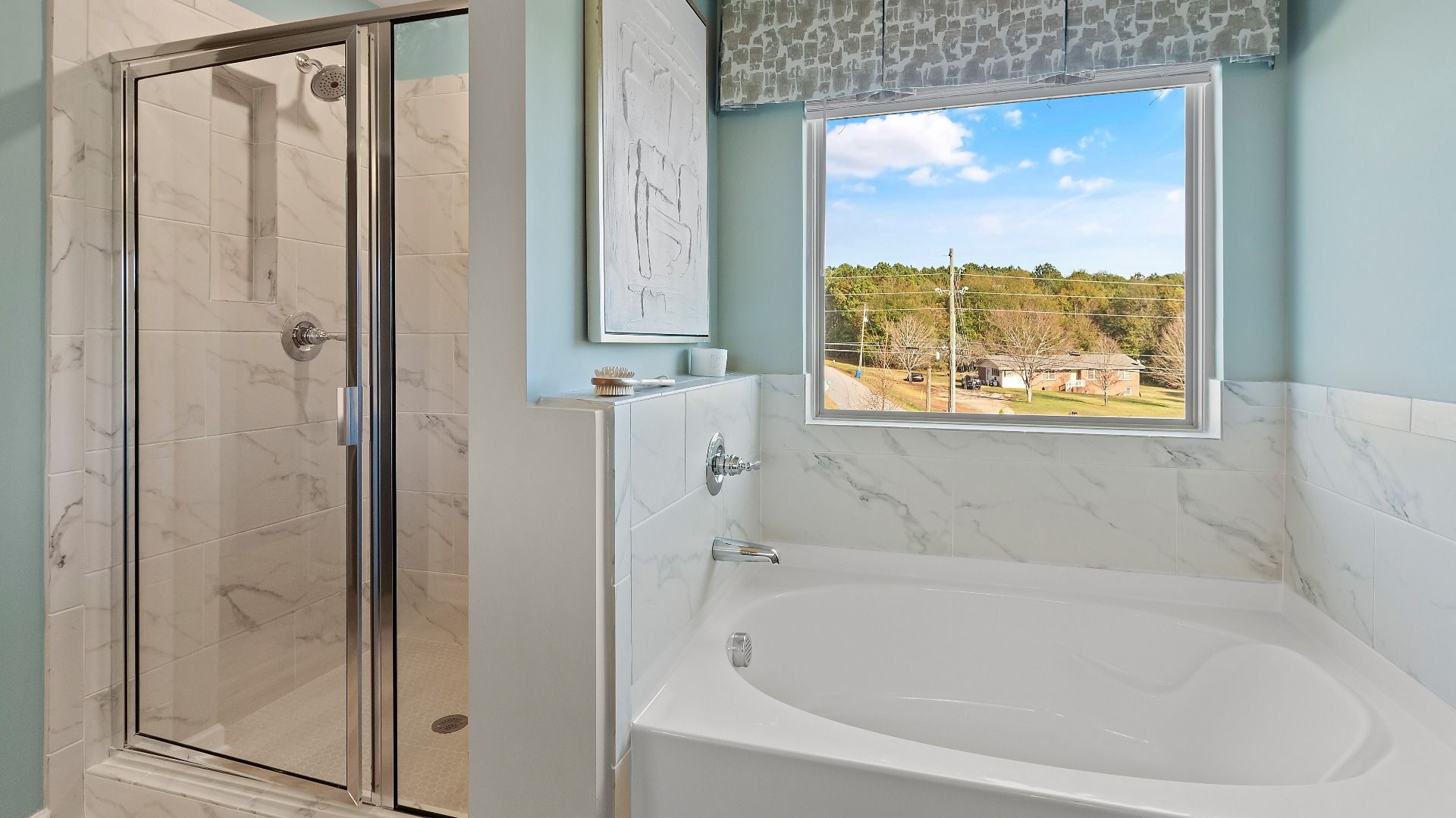 Luxury primary bathroom with soaking tub and tile shower in new construction home at Adagio in Dacula, Georgia.