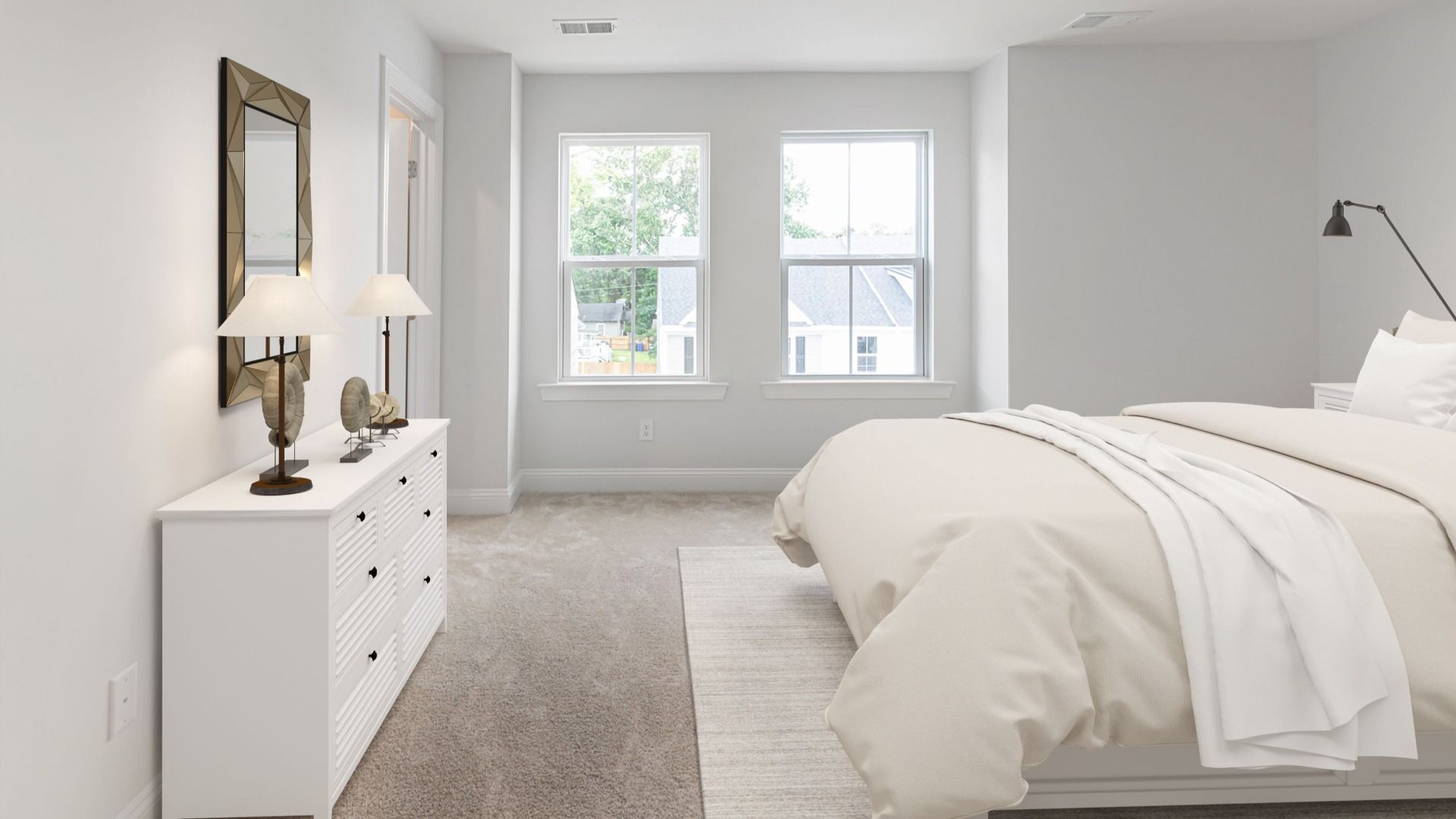 Carpeted owner's suite with two large windows on single wall in a DRB Homes Brookgreen model home at Park Circle Station.