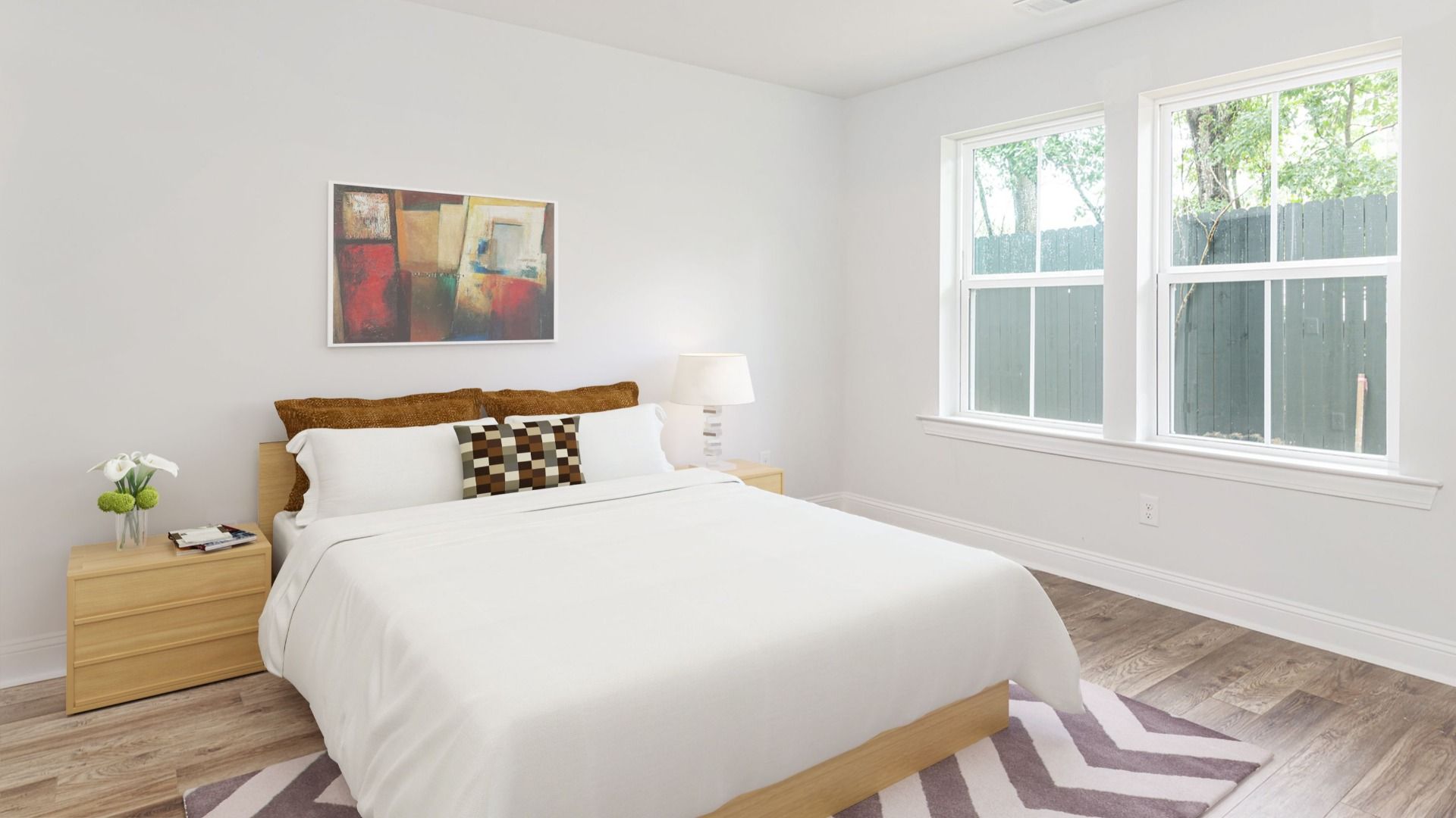 Secondary bedroom with 2 large windows on single wall  in a DRB Homes Brookgreen model home at Park Circle Station.
