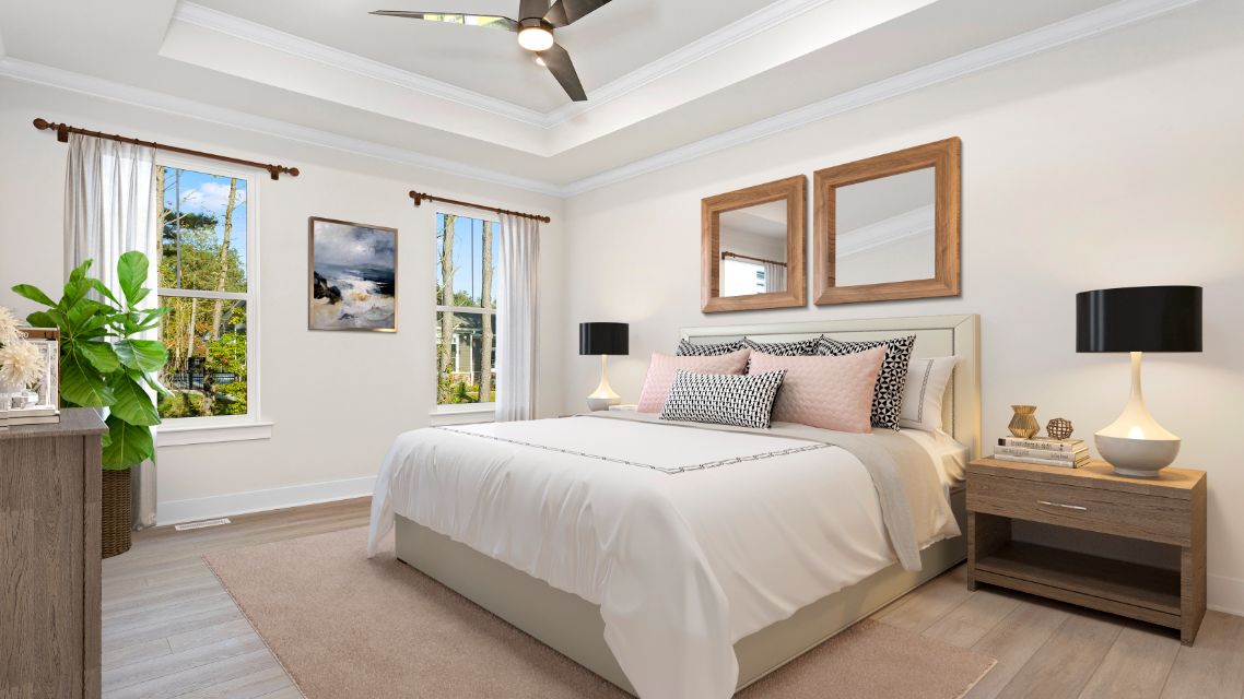 Owner's suite with tray ceiling and 2 large windows on one wall in DRB Homes Latitude home.