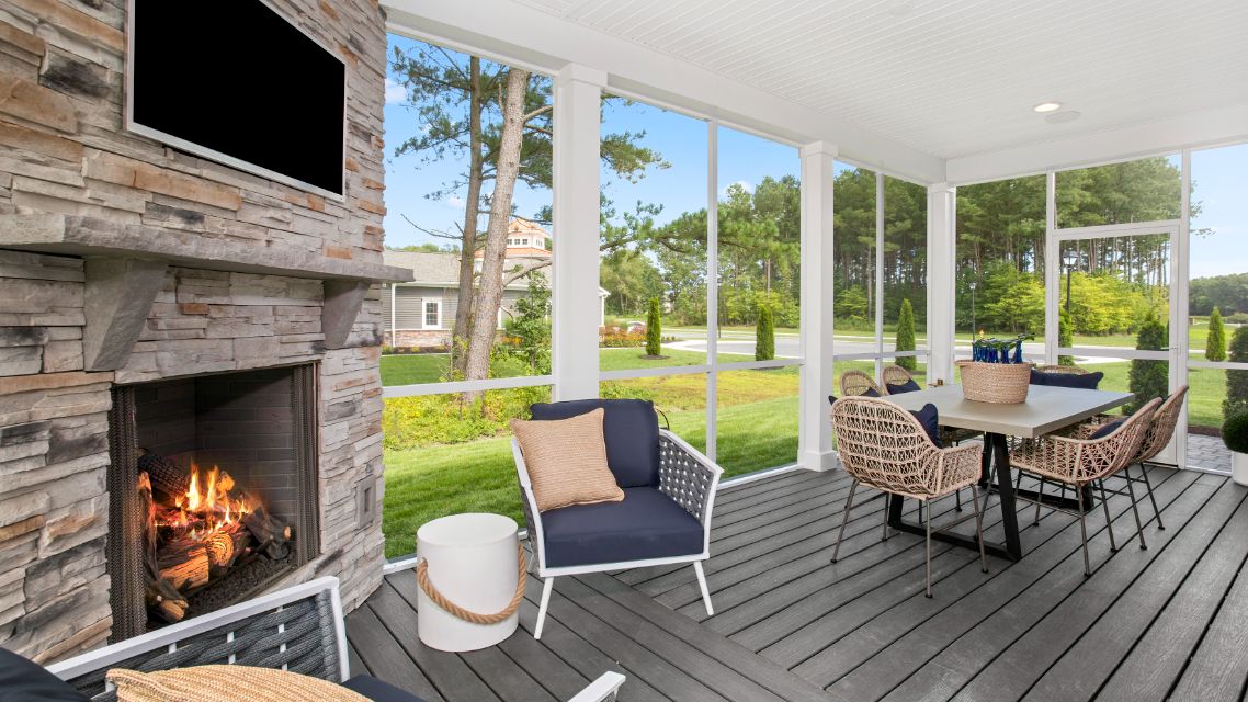 Screened porch with corner fireplace in a DRB Homes St. Kitts Model Home.