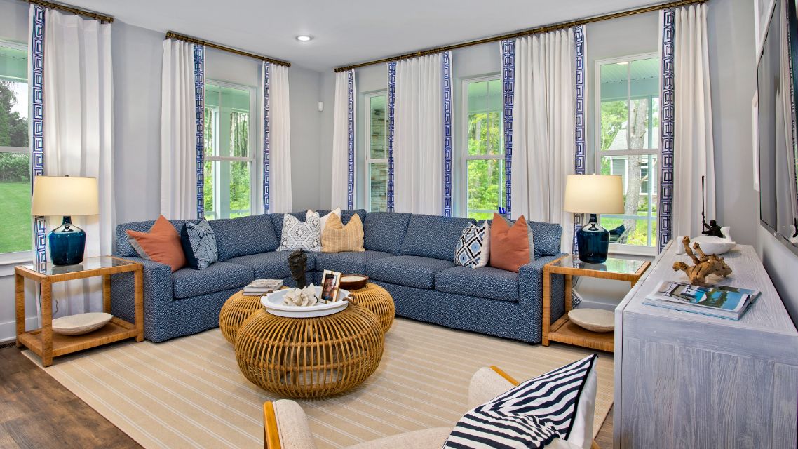 Morning room with seating and surrounded by large windows in a DRB Homes St. Kitts Model Home.