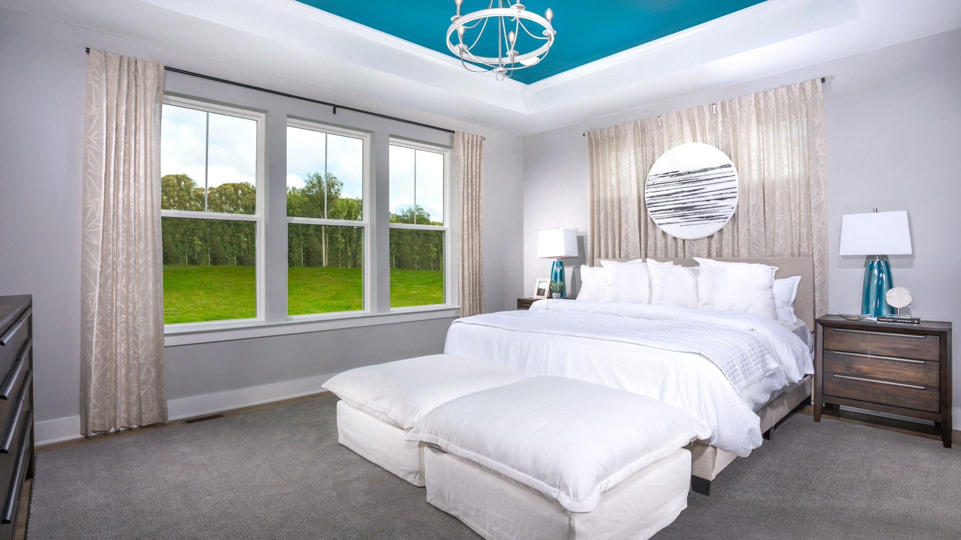 Owner's suite with tray ceiling and large triple window in a DRB Homes St. John Model Home.