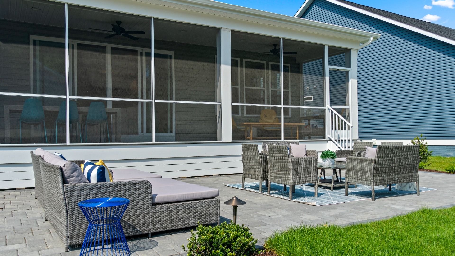 Screened porch and patio with seating areas in a DRB Homes St. John Model Home.