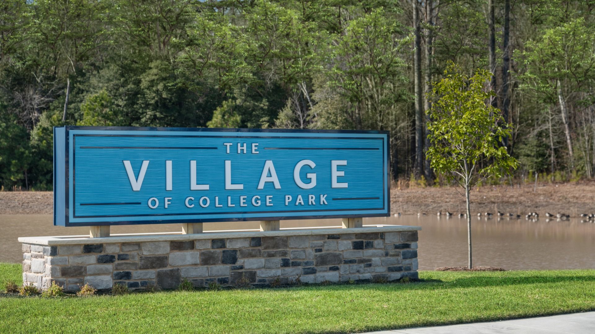 Blue façade community entrance sign to Villages at College Park
