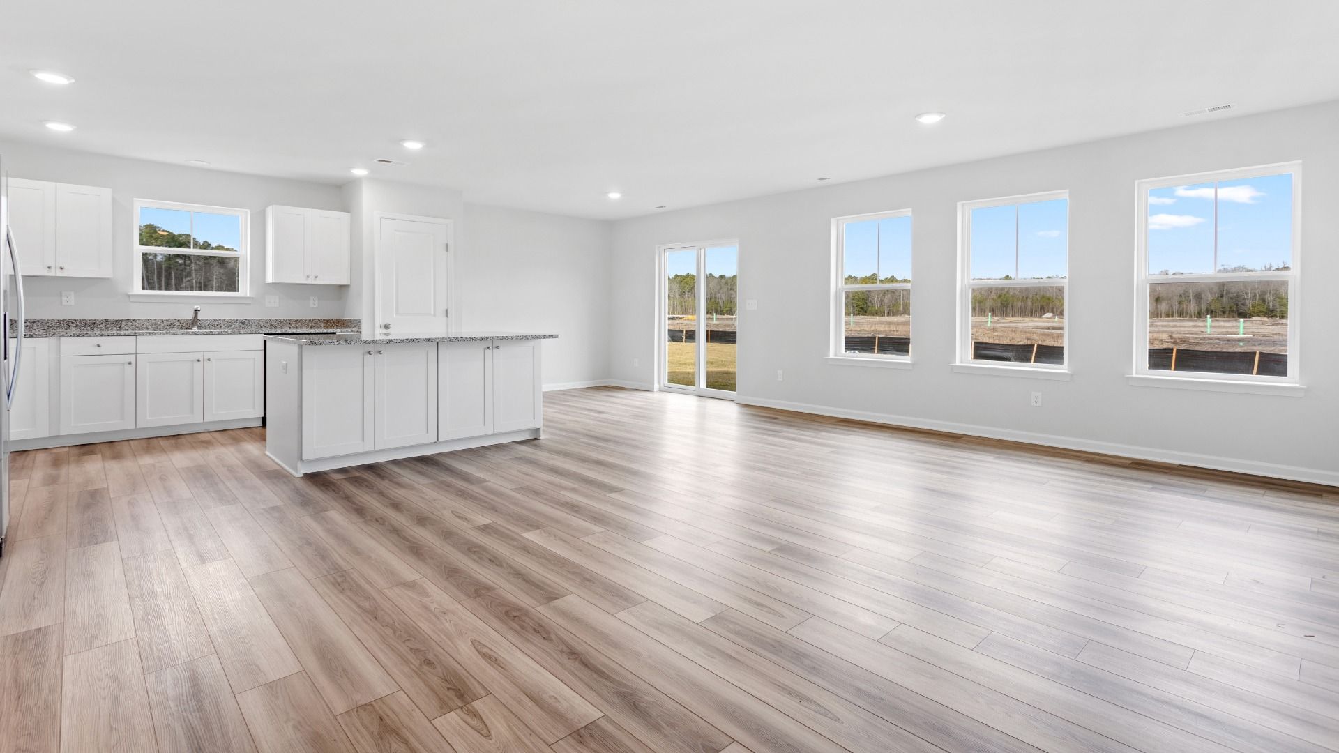 Open kitchen and family room in a DRB Homes Edgewood plan at The Village of College Park community.