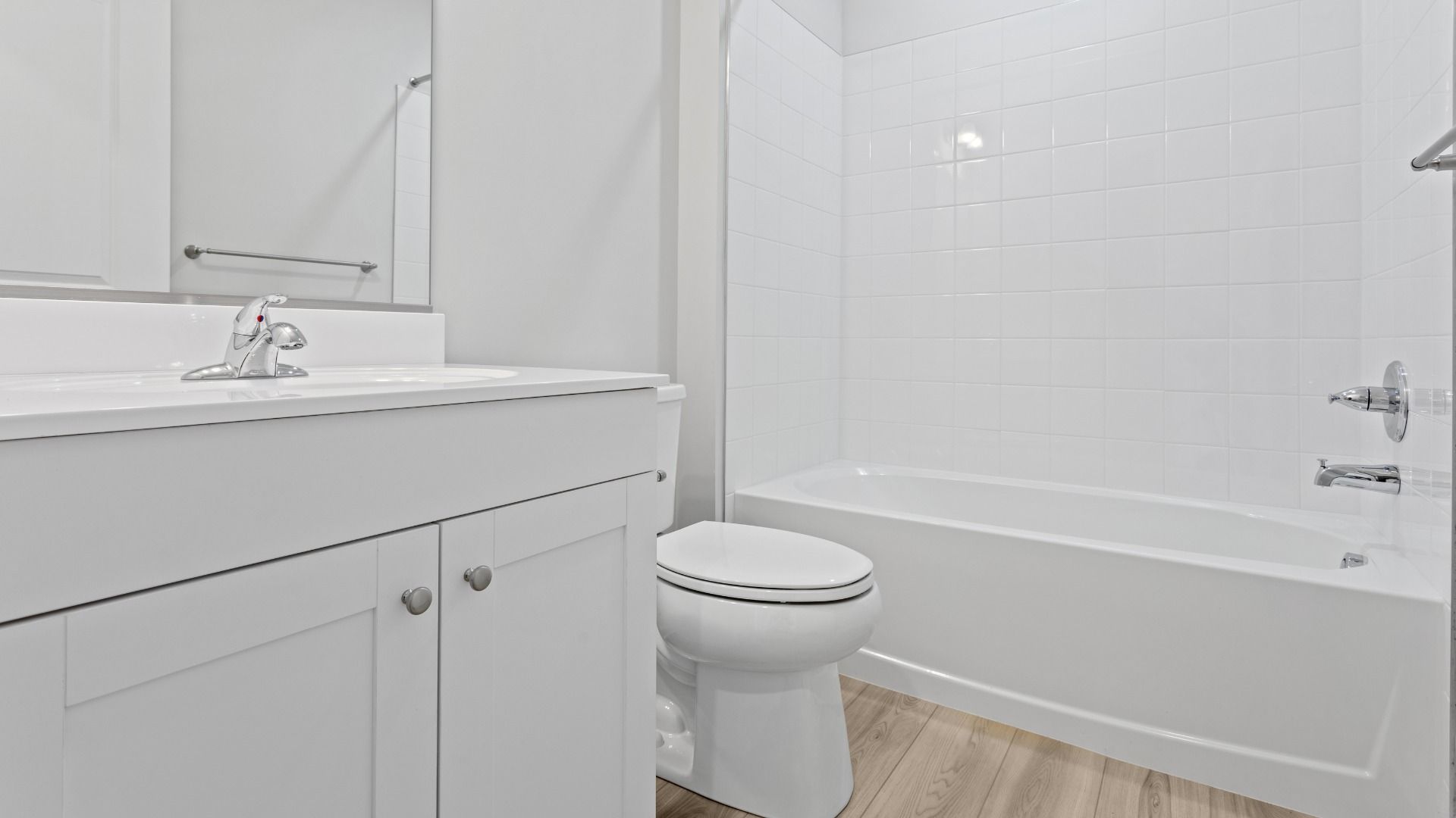Full bath with white vanity and shower/tub combo in a DRB Homes Edgewood plan at The Village of College Park community.