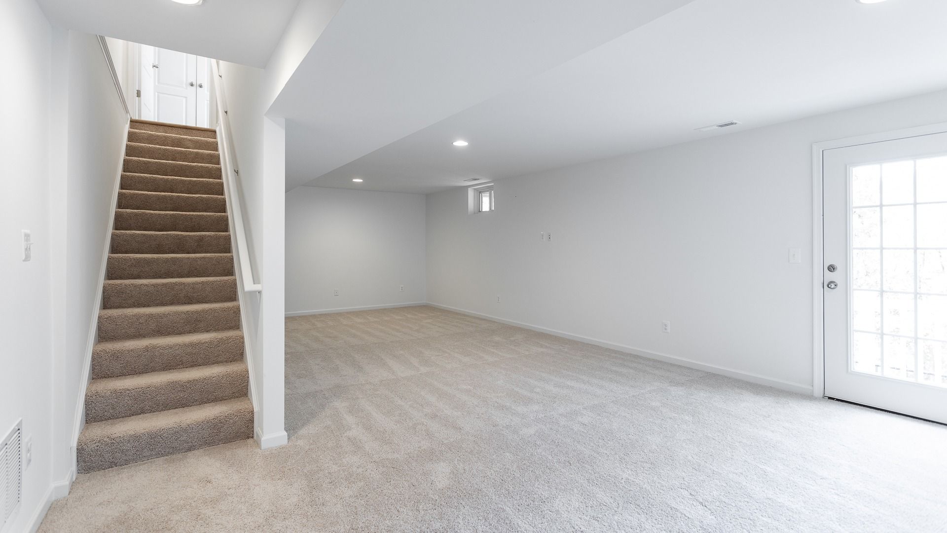 Finished Basement with Access to the Backyard in a DRB Homes Glenshaw plan at The Village of College Park.