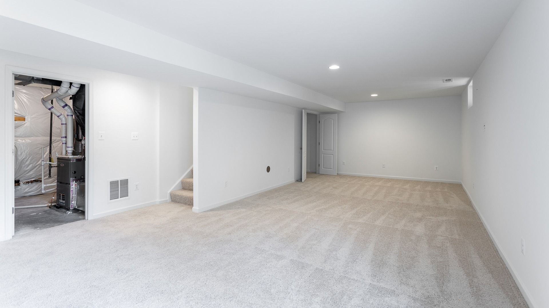 Finished Basement with Access to the Backyard in a DRB Homes Glenshaw plan at The Village of College Park.