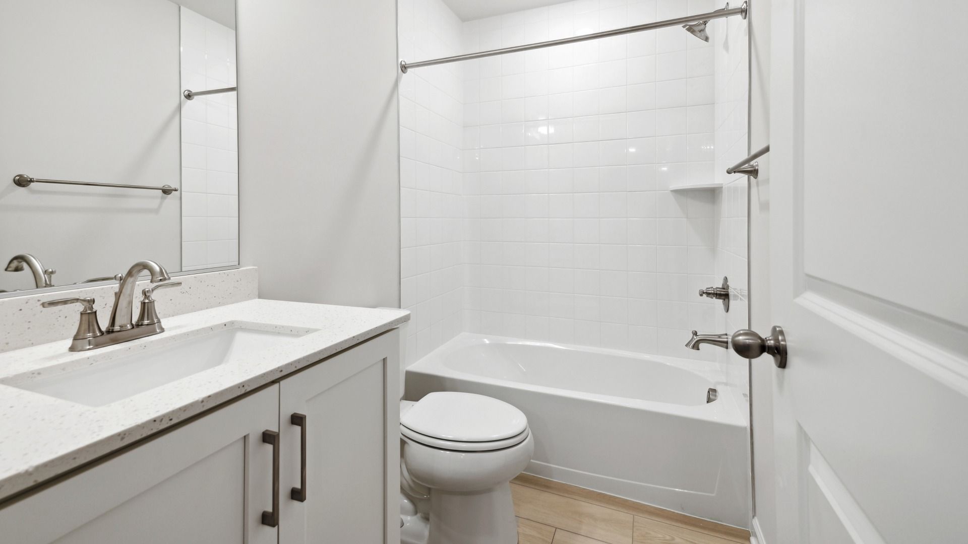 Hall Bathroom with Quartz Countertops in the Whitehall at The Village of College Park by DRB Homes.