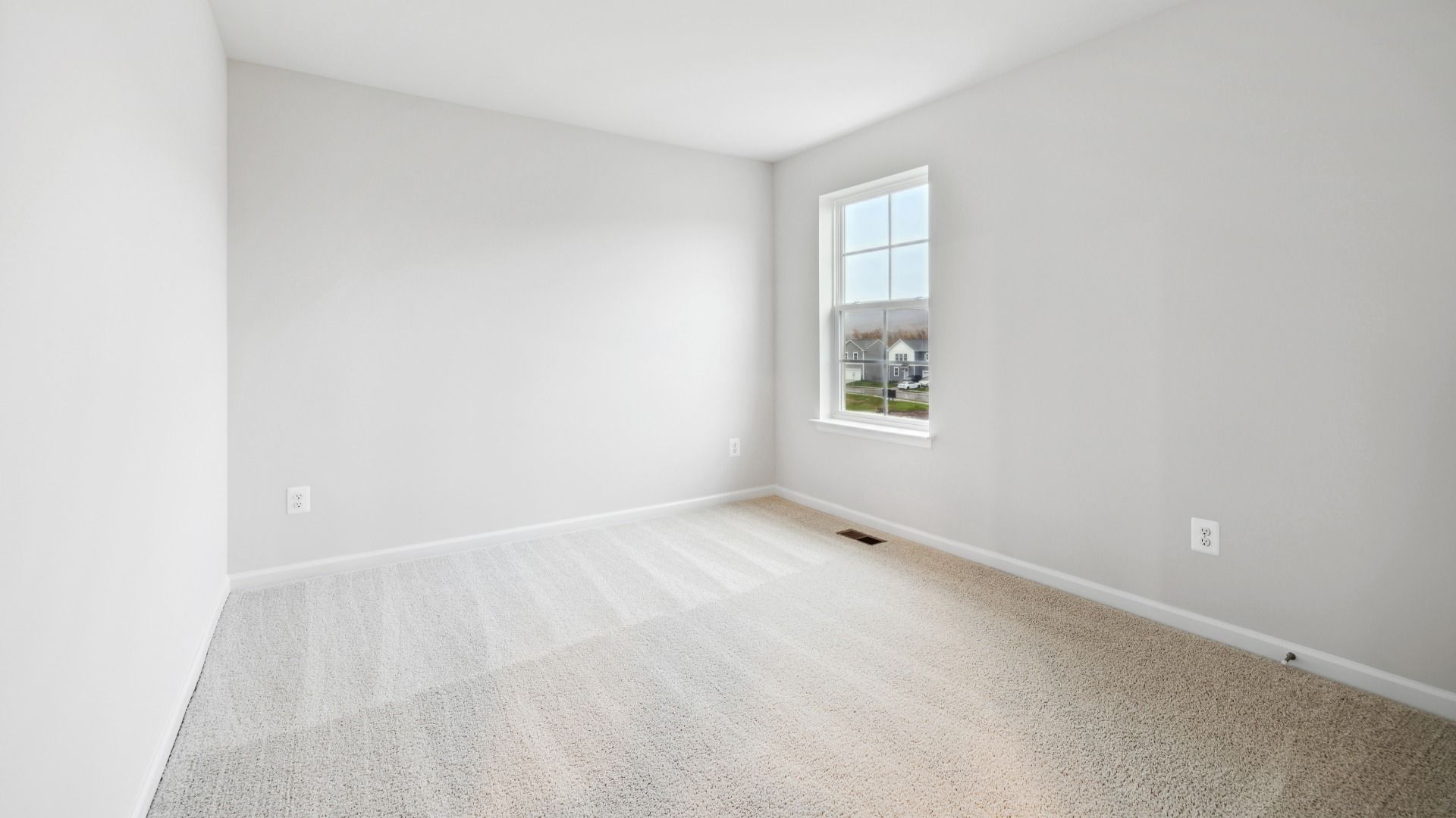 Spacious Secondary Bedroom with Carpet in the Whitehall at The Village of College Park by DRB Homes.