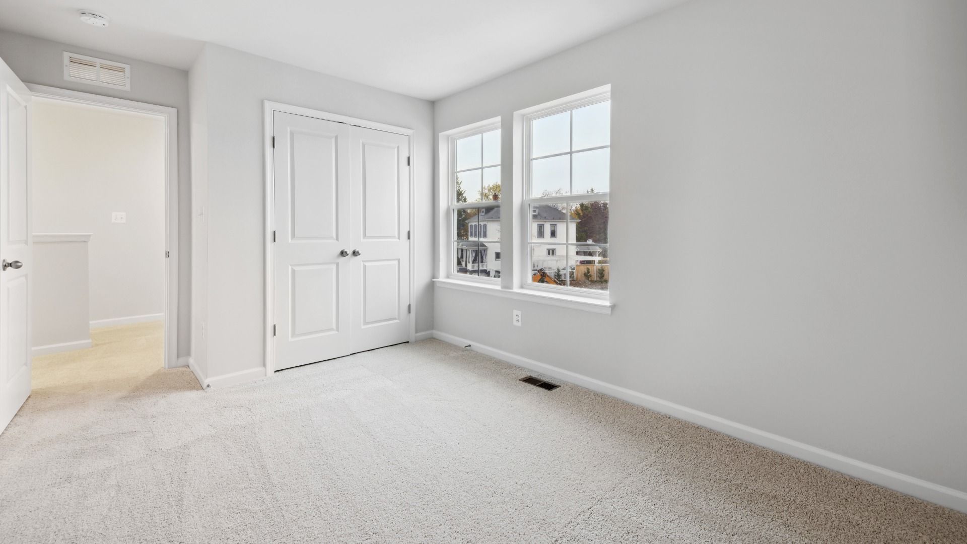 Spacious Secondary Bedroom with Carpet in the Whitehall at The Village of College Park by DRB Homes.