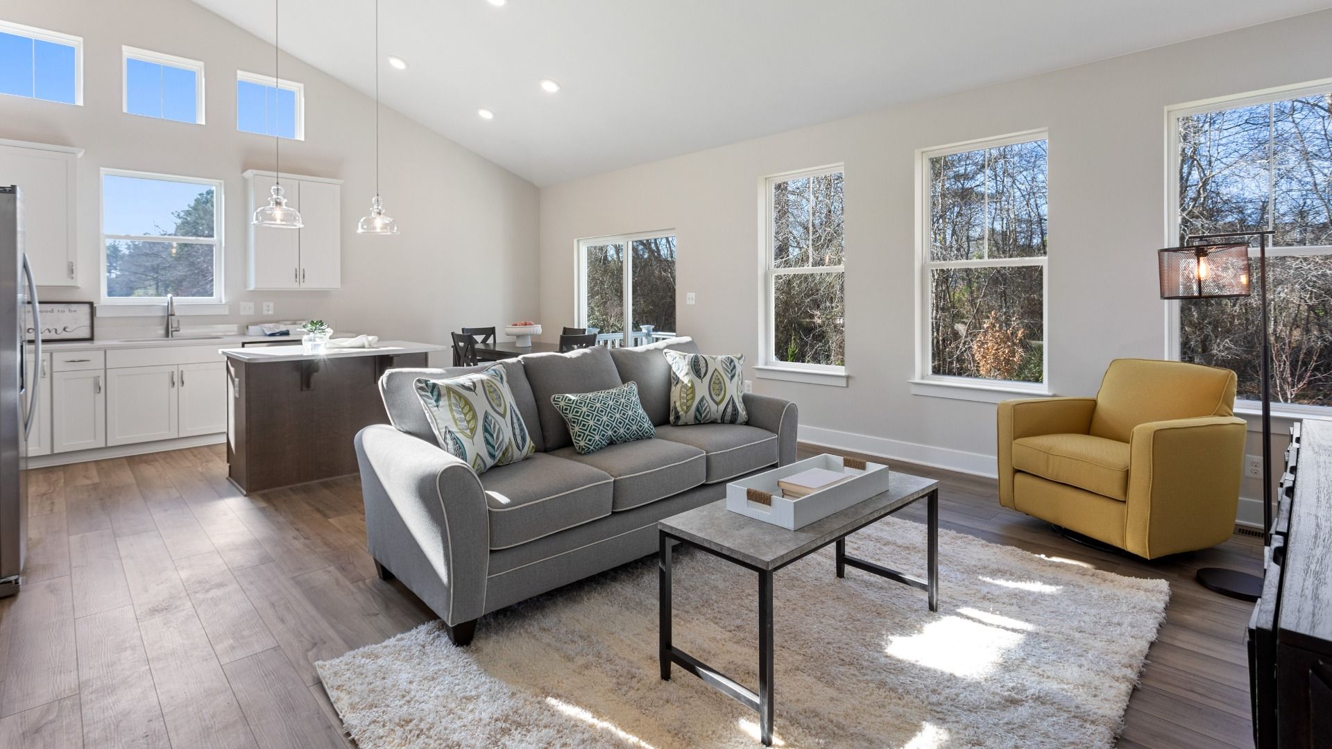 Family room with vaulted ceiling and an abundance of natural light in the DRB Homes Aloha model in the Wetherby community.
