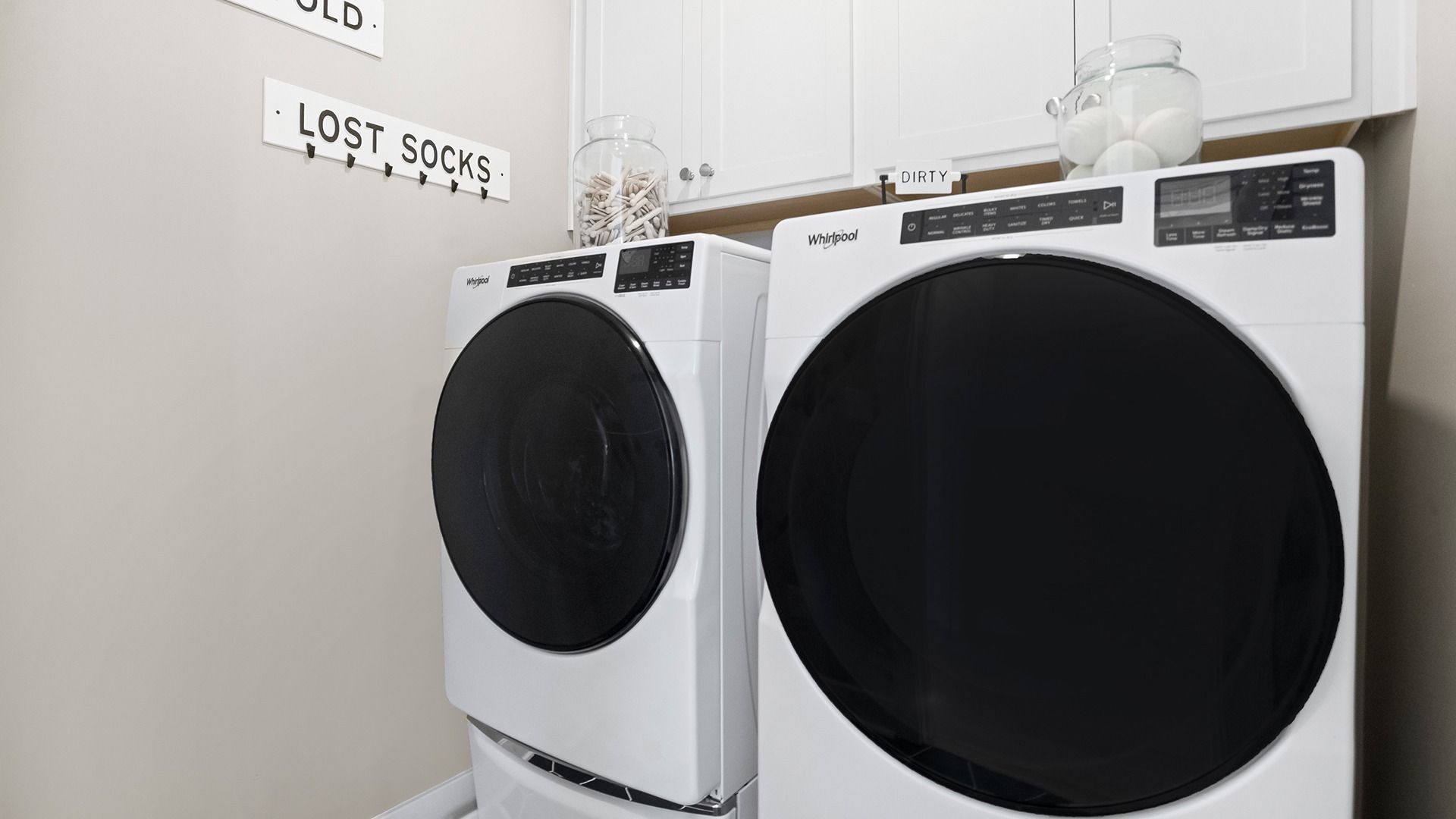 Laundry Room with overhead Cabinetry for Extra Storage in the St. Kitts model at Wetherby