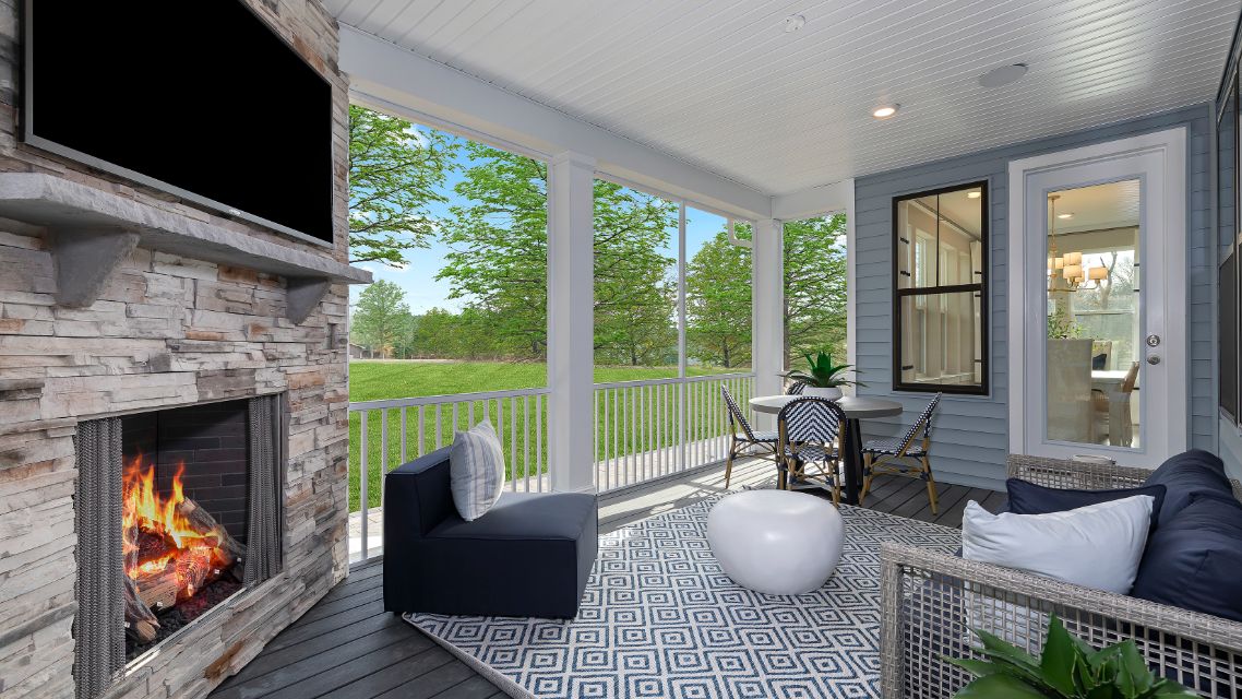 Screened porch with corner gas fireplace and recessed lights n a DRB Homes Barbados model home in The Estuary community.