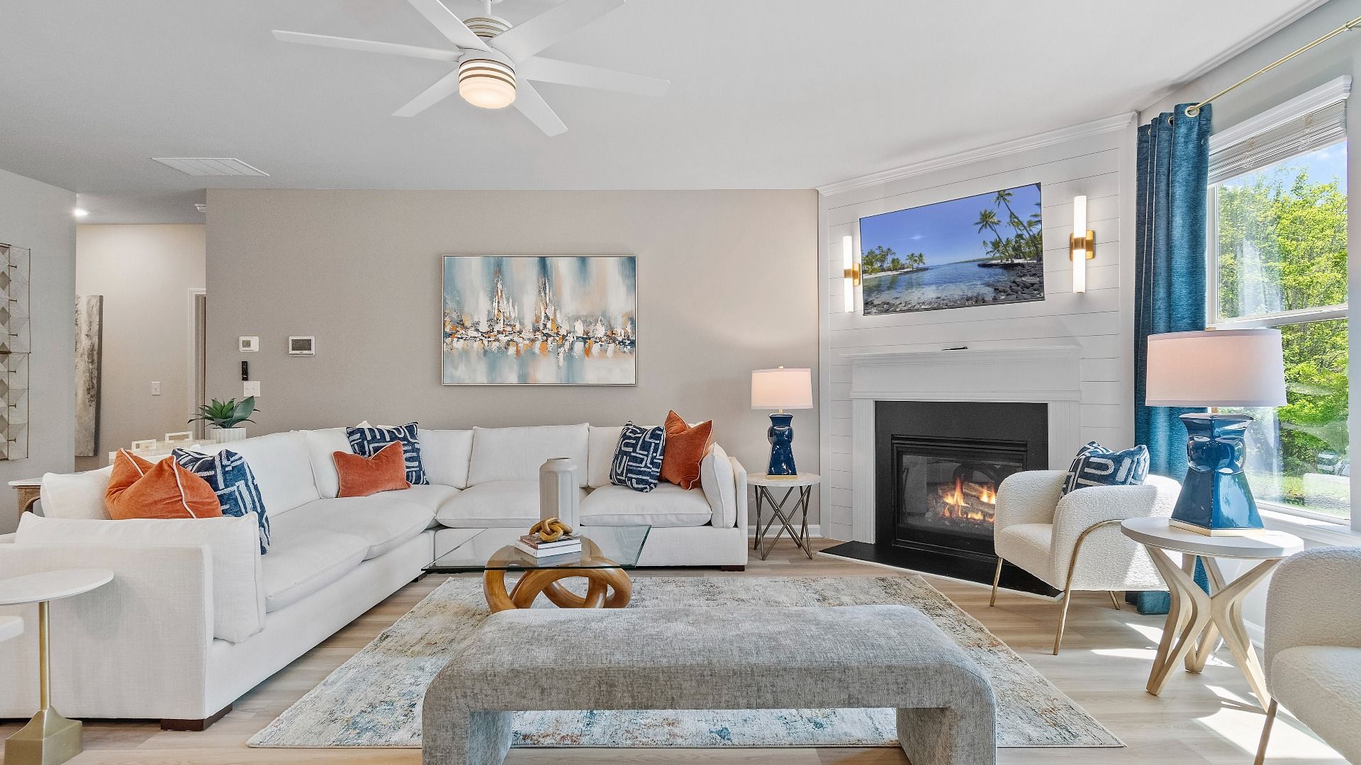 Spacious family room with corner gas fireplace and large window at Kingston in Locust Grove, GA.