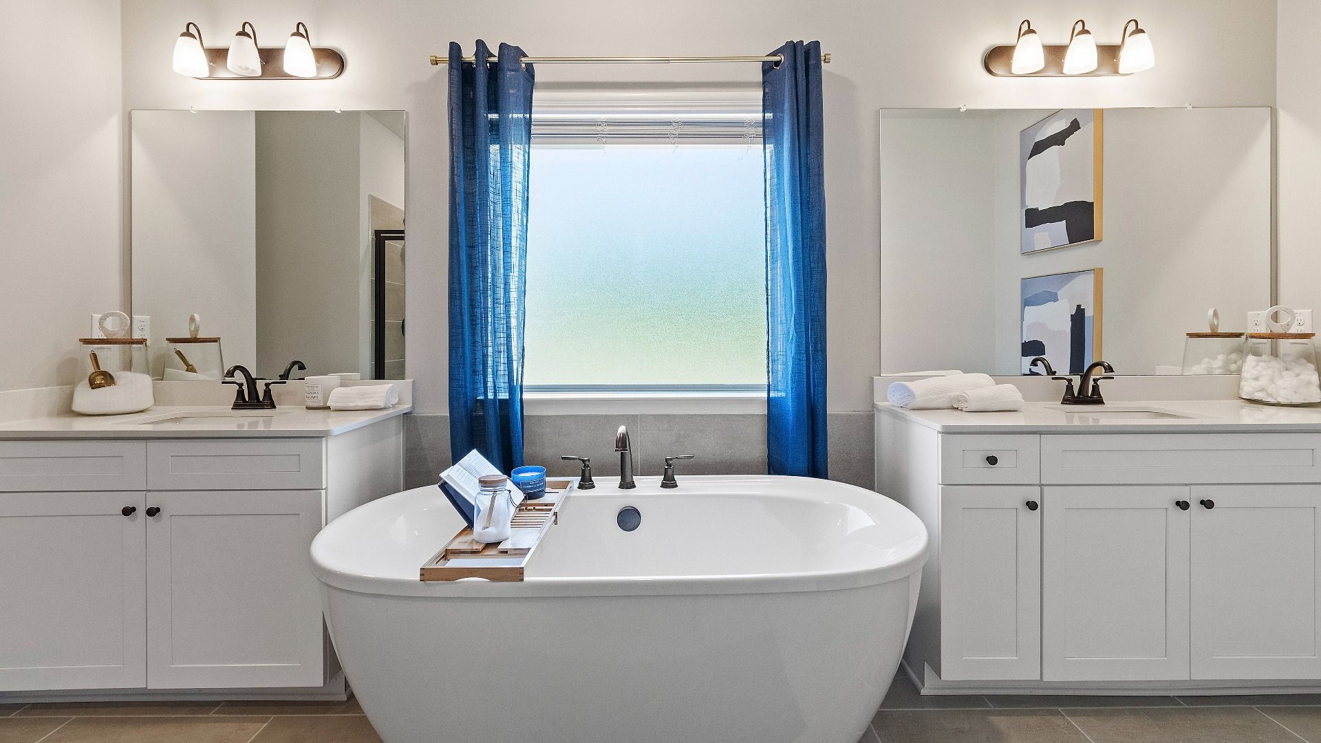 Modern primary bath with tub and dual vanities at Kingston in Locust Grove, GA.