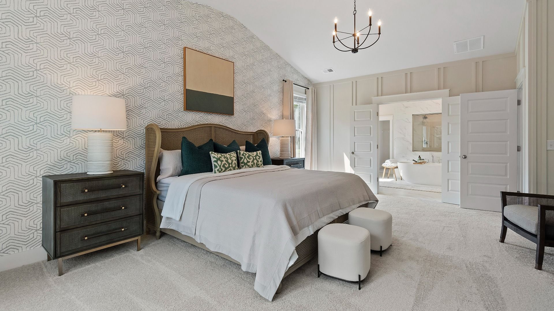Spacious primary suite with a relaxing retreat feel and modern neutral design at Saddleridge in Senoia, GA.