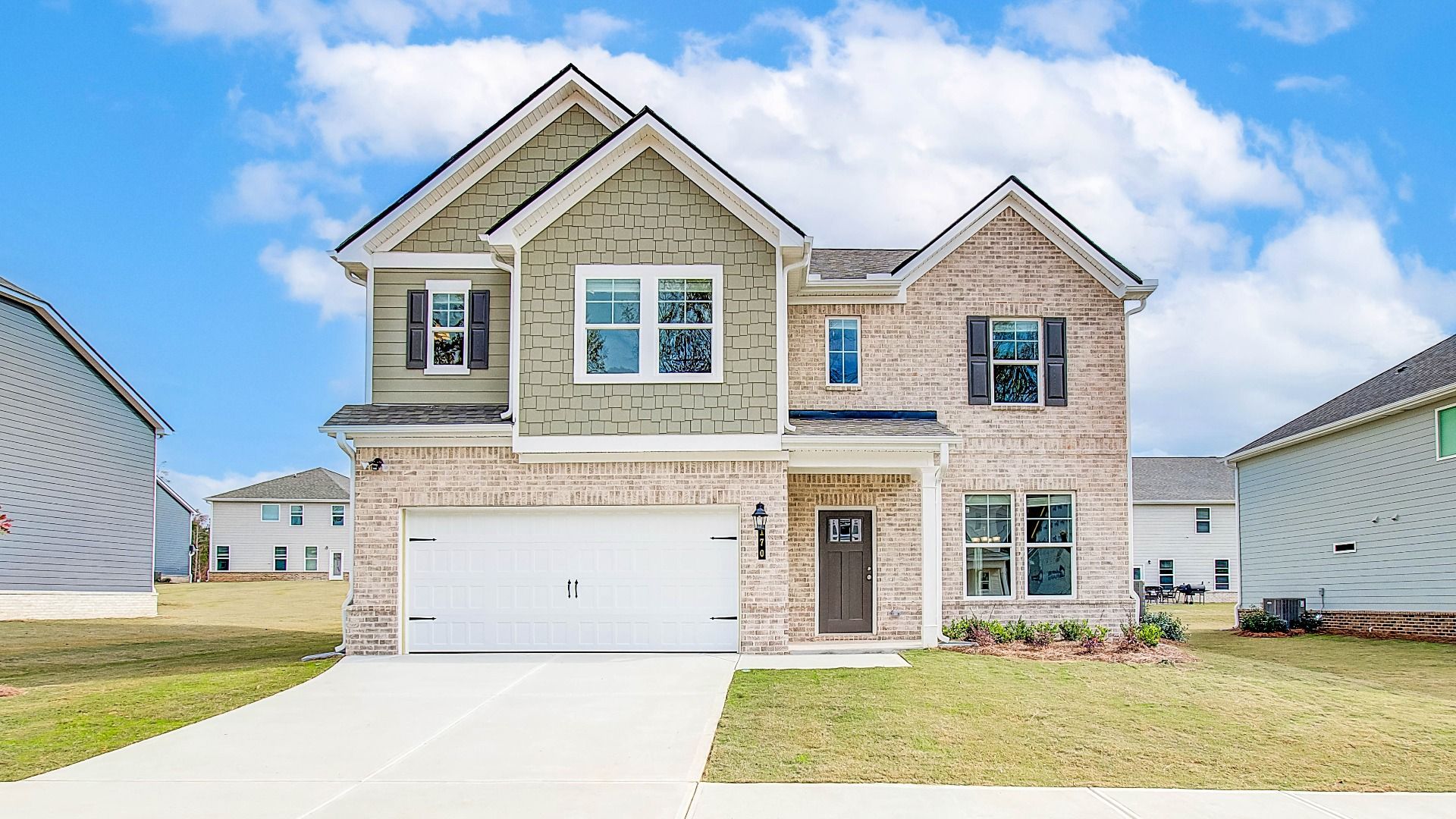 Radcliffe two-story new construction single family home featuring brick and siding exterior at Westminster in Covington, GA.