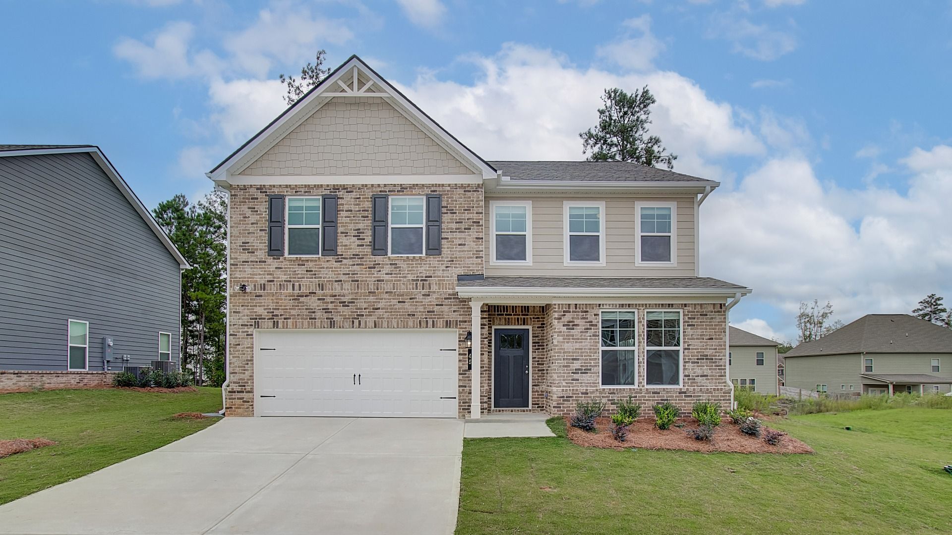 Everest III two-story home with brick and siding exterior and front-entry garage at Westminster in Covington, GA.