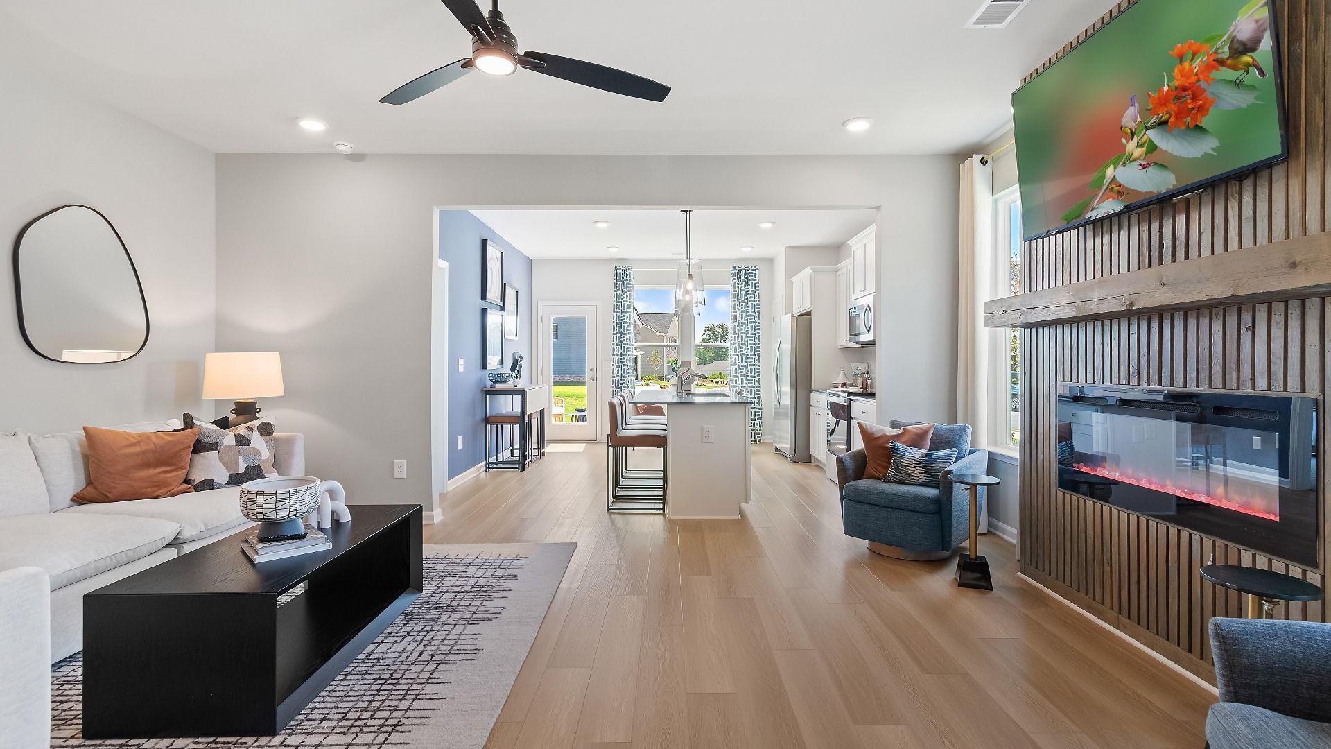 Open-concept family room with electric fireplace and modern finishes at Westminster in Covington, GA.