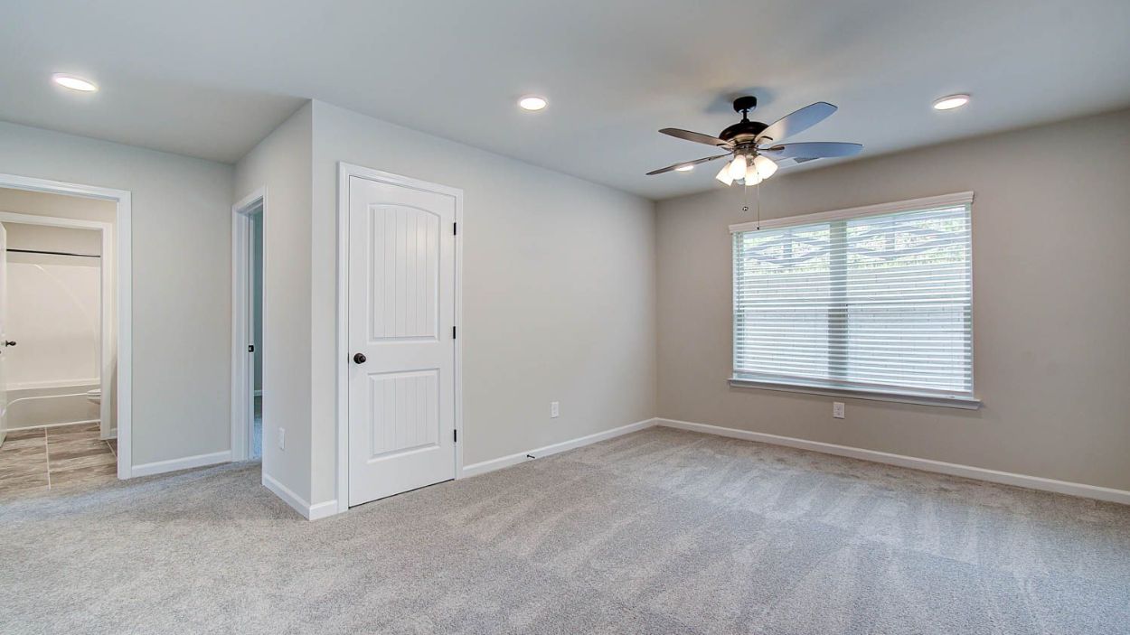 Secondary bedroom with carpet flooring, natural light, and connecting bath in the Vickery at Berkeley Lakes.