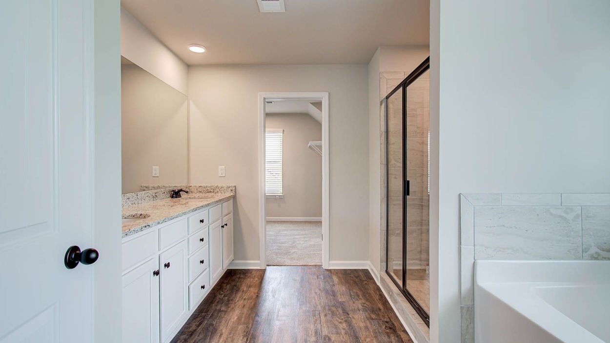 Vickery primary bath with dual vanities, walk-in shower, standalone tub, and neutral modern finishes at Berkeley Lakes.