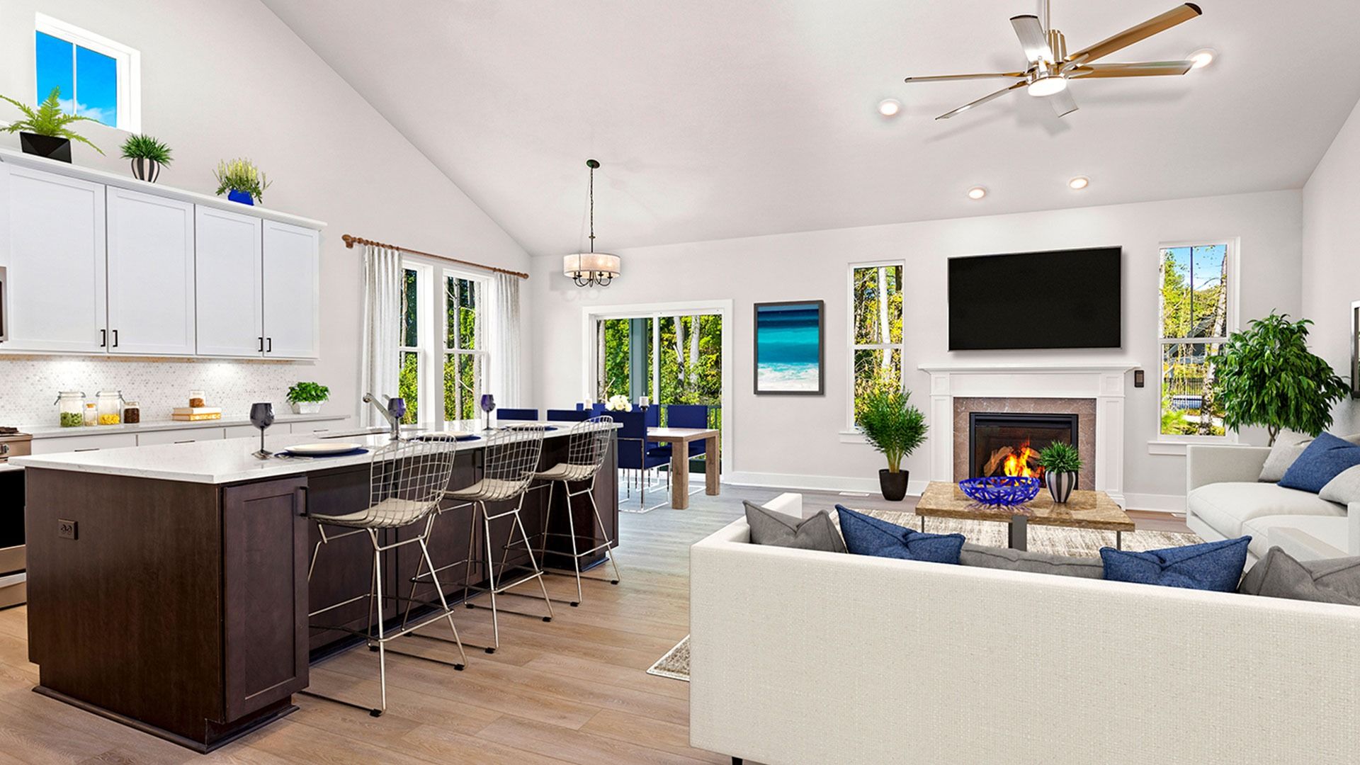 Kitchen and  family room with fireplace and vaulted ceiling in a DRB Homes Latitude home.