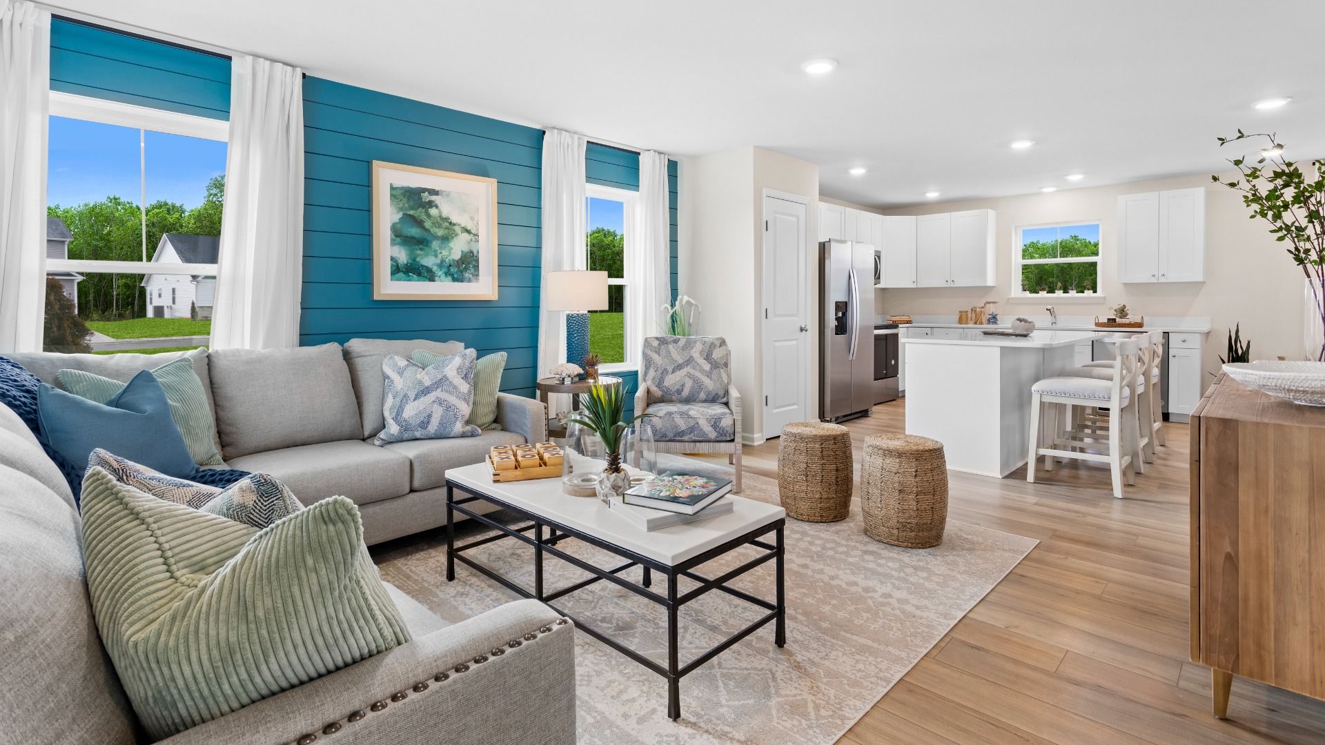 Open main level living room and kitchen in a DRB Homes Whitehall Model at the Village of College Park community.