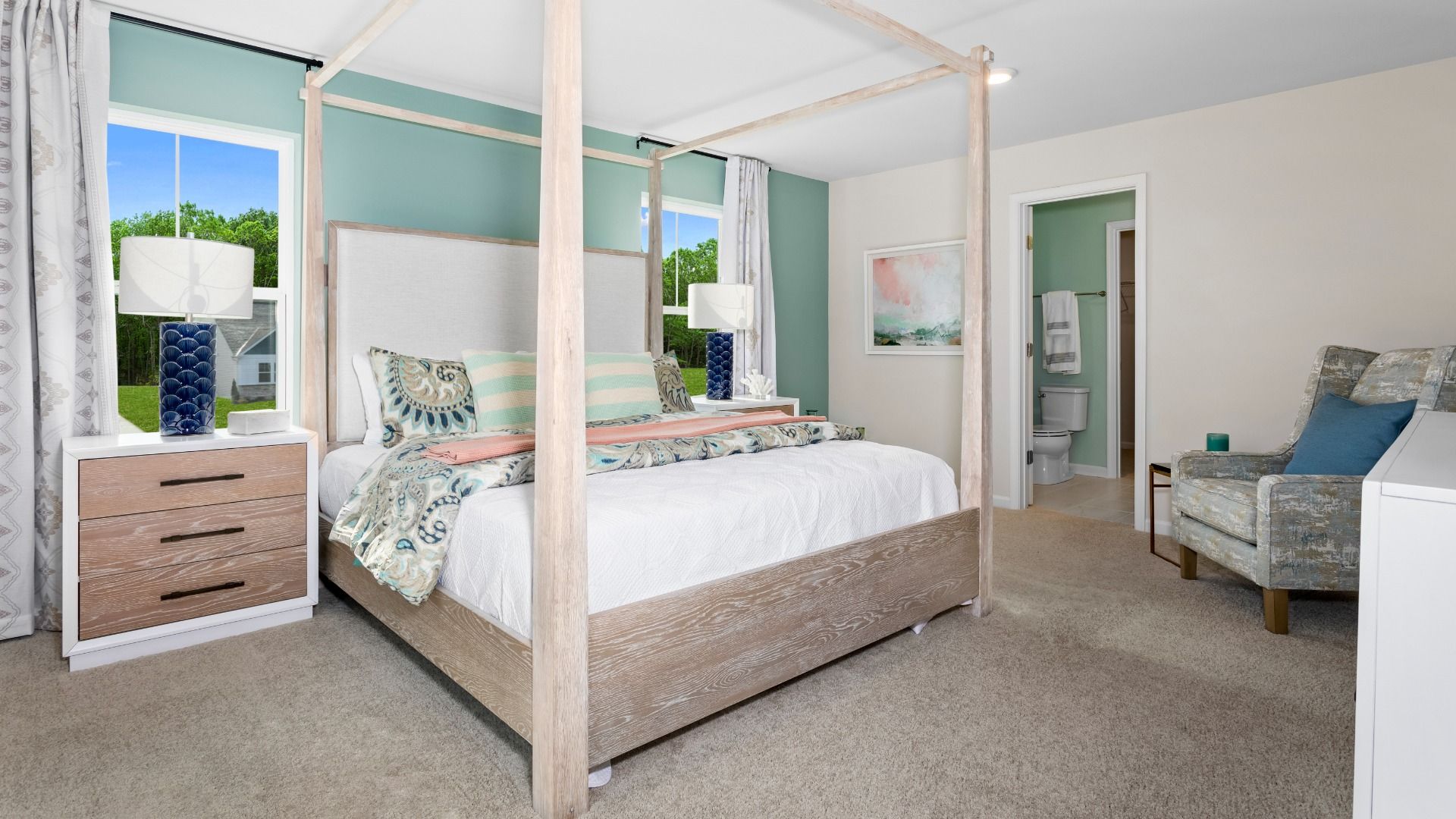 Carpeted owner's Suite with 2 large windows in a DRB Homes Whitehall Model at the Village of College Park community.